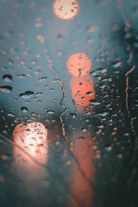 Raindrops on Window with Blurred Lights