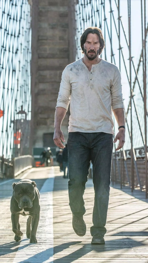 Keanu Reeves Walks With Dog On Bridge