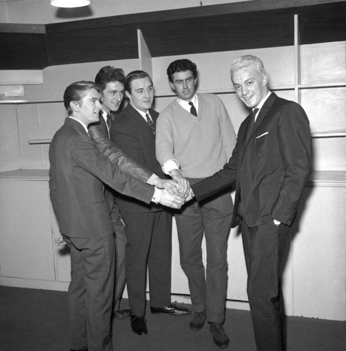Five Men Stacking Hands Together