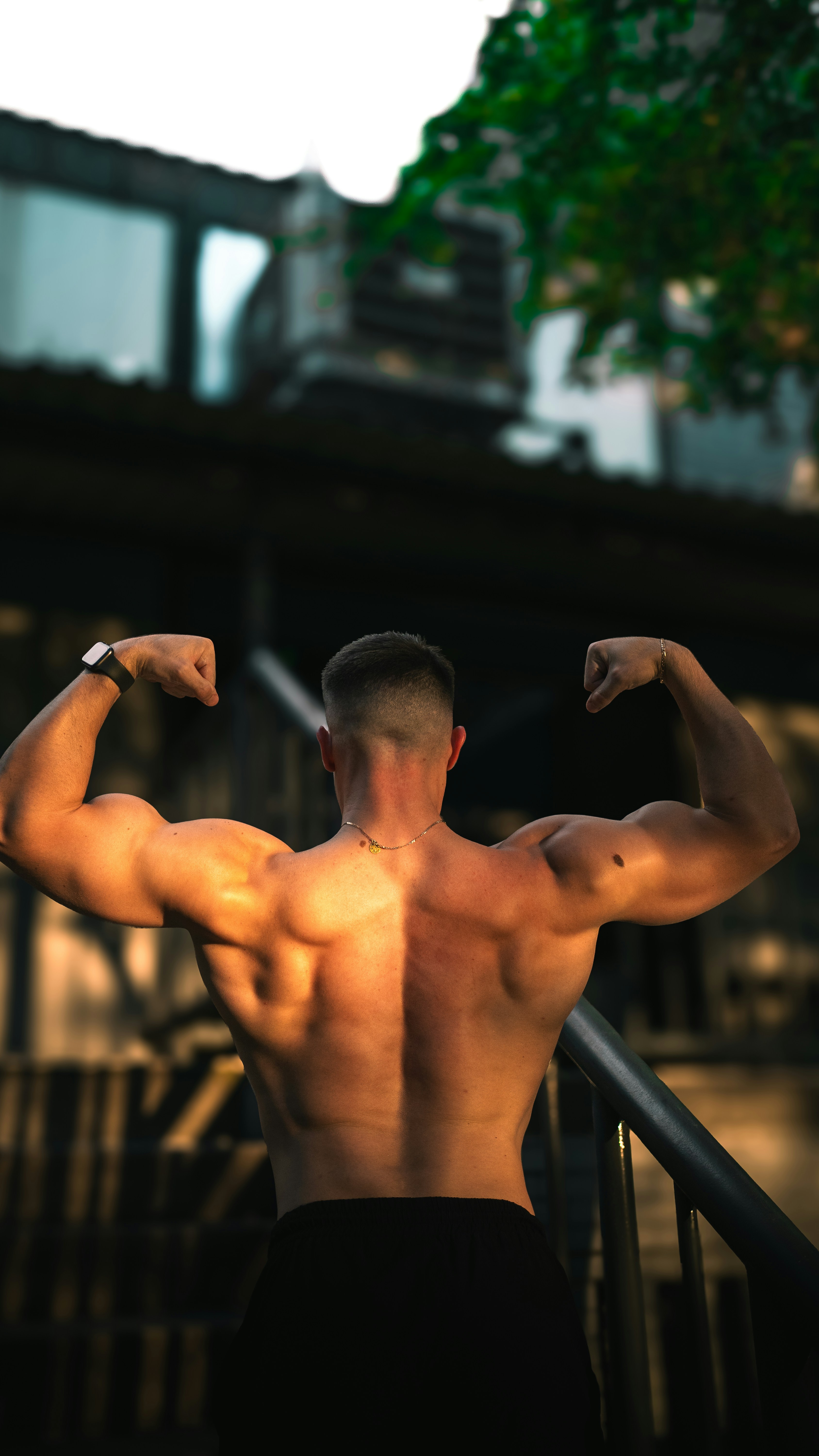 Muscular Man Flexing Back Outdoors