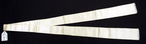 Folded Off-White Sash on Black Background