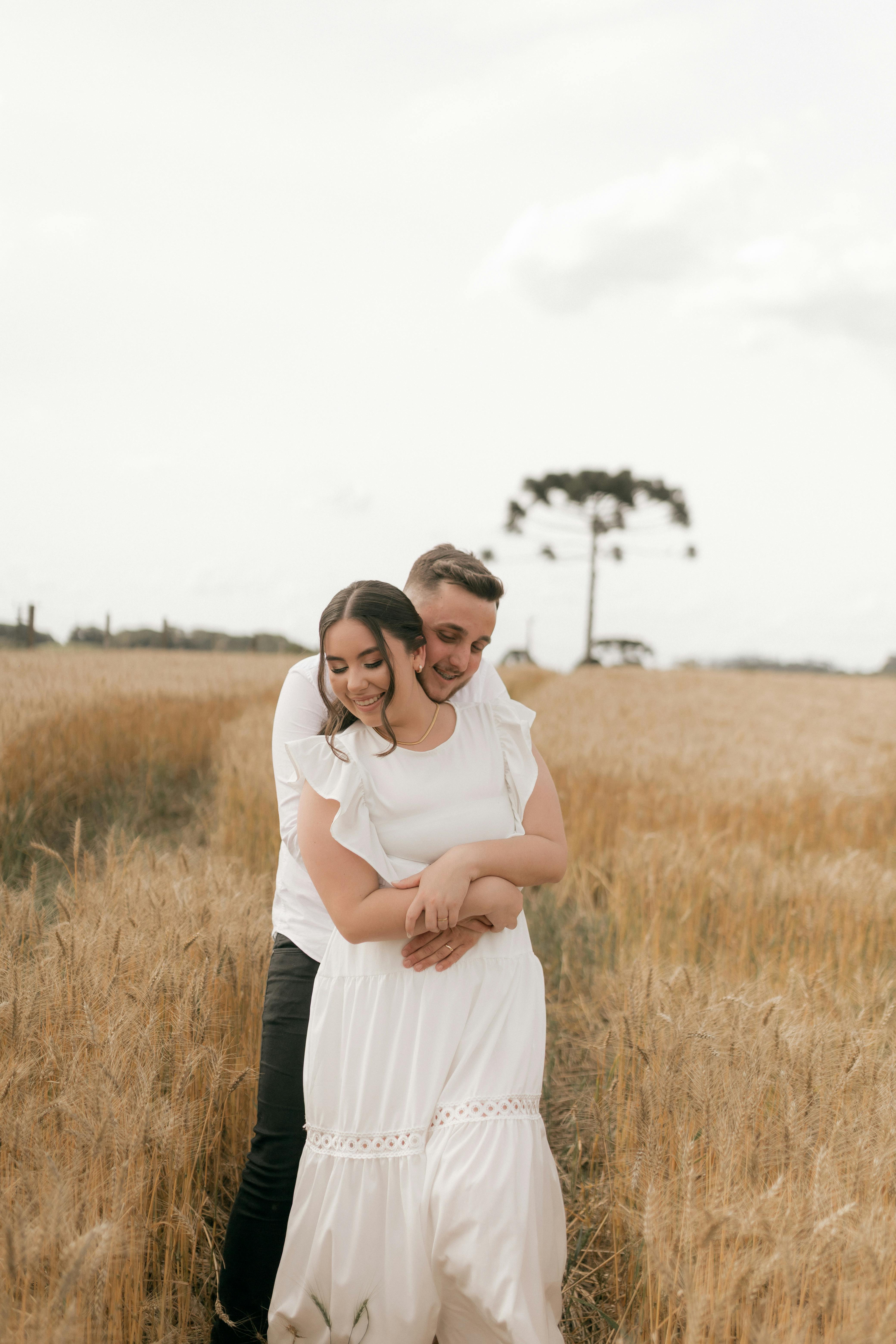 Couple Embracing in Golden Wheat Field
