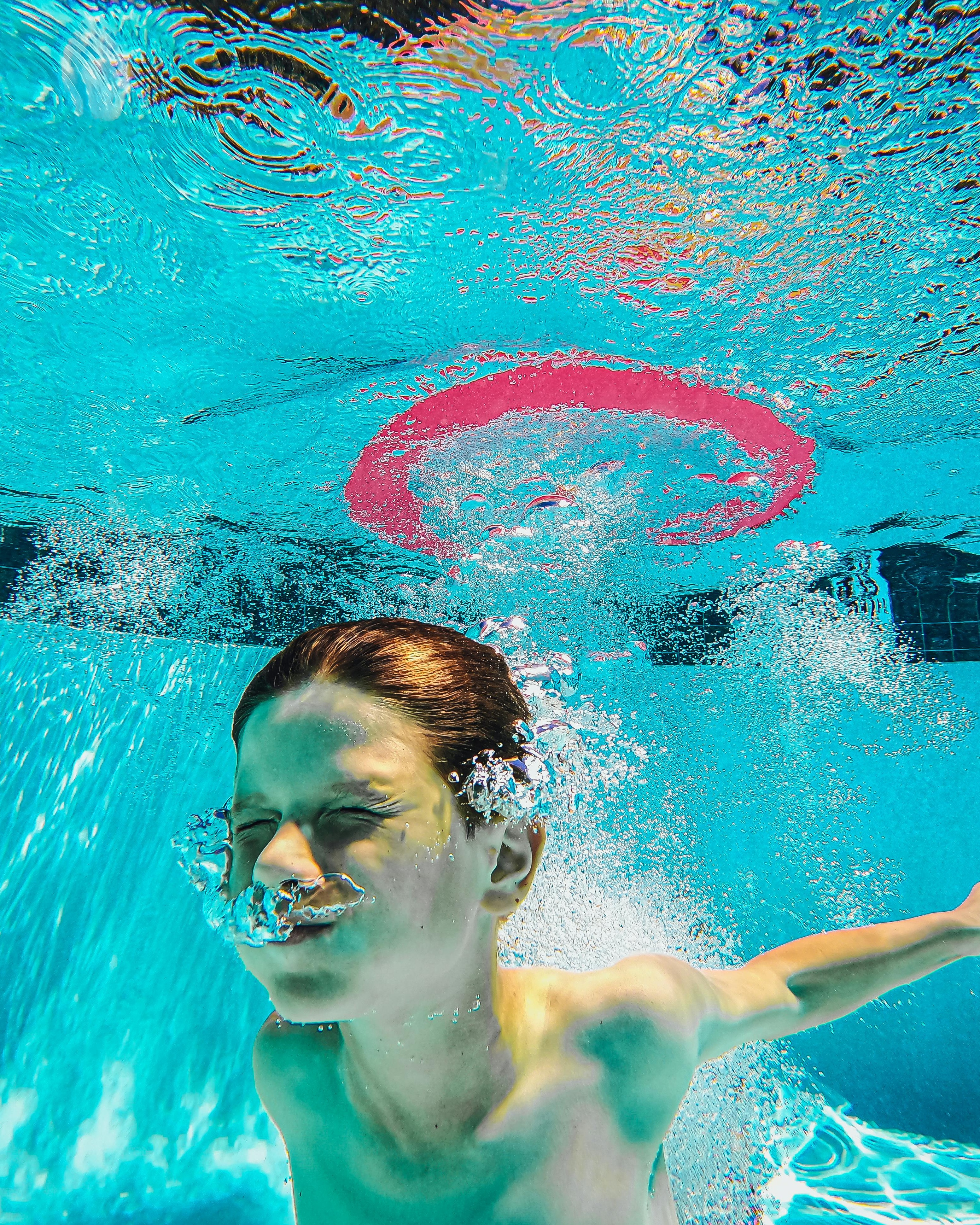 Boy Swimming Underwater in Pool