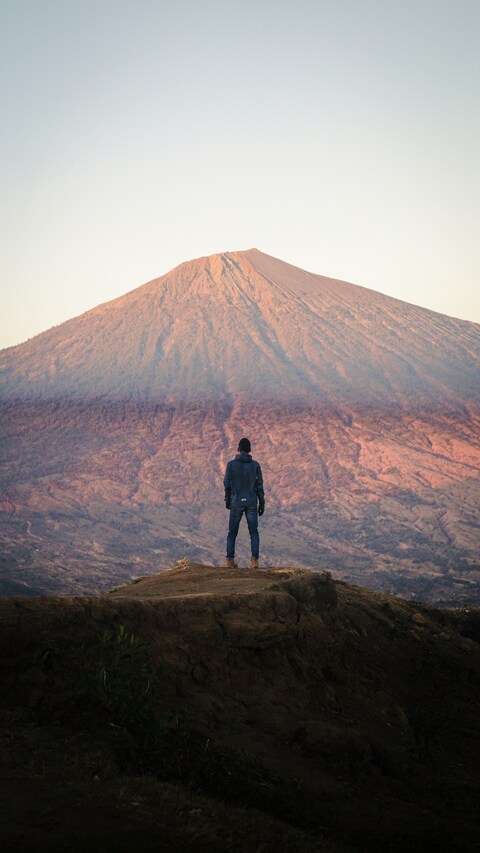 Hiker Overlooking Distant Mountain