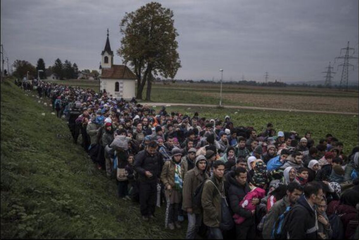 Line of Migrants Walking Through Countryside