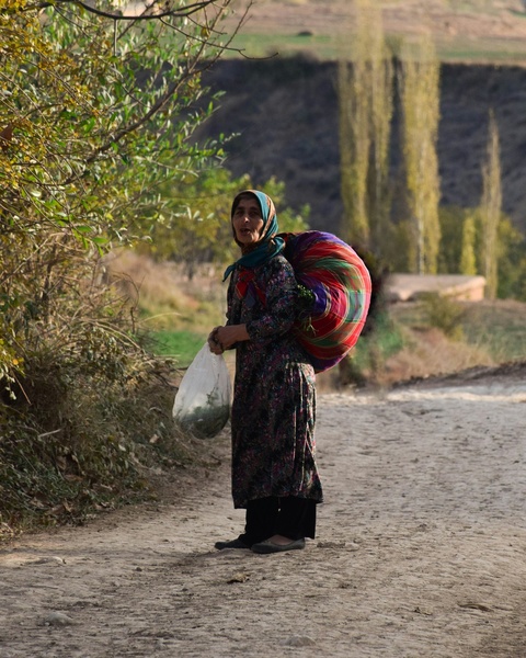 Elderly Rural Woman Carrying Harvest