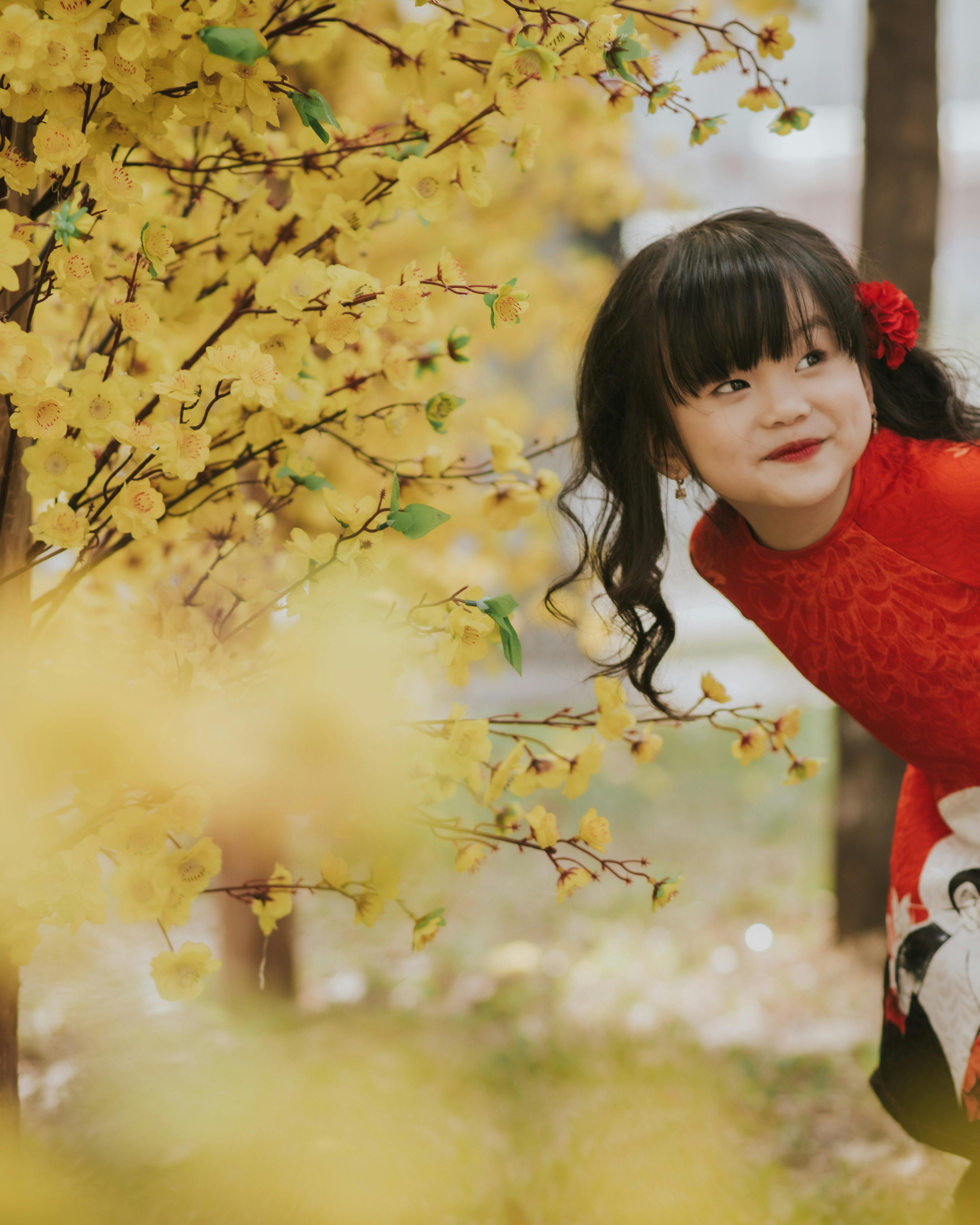 Little Girl Beside Yellow Blossom Branches