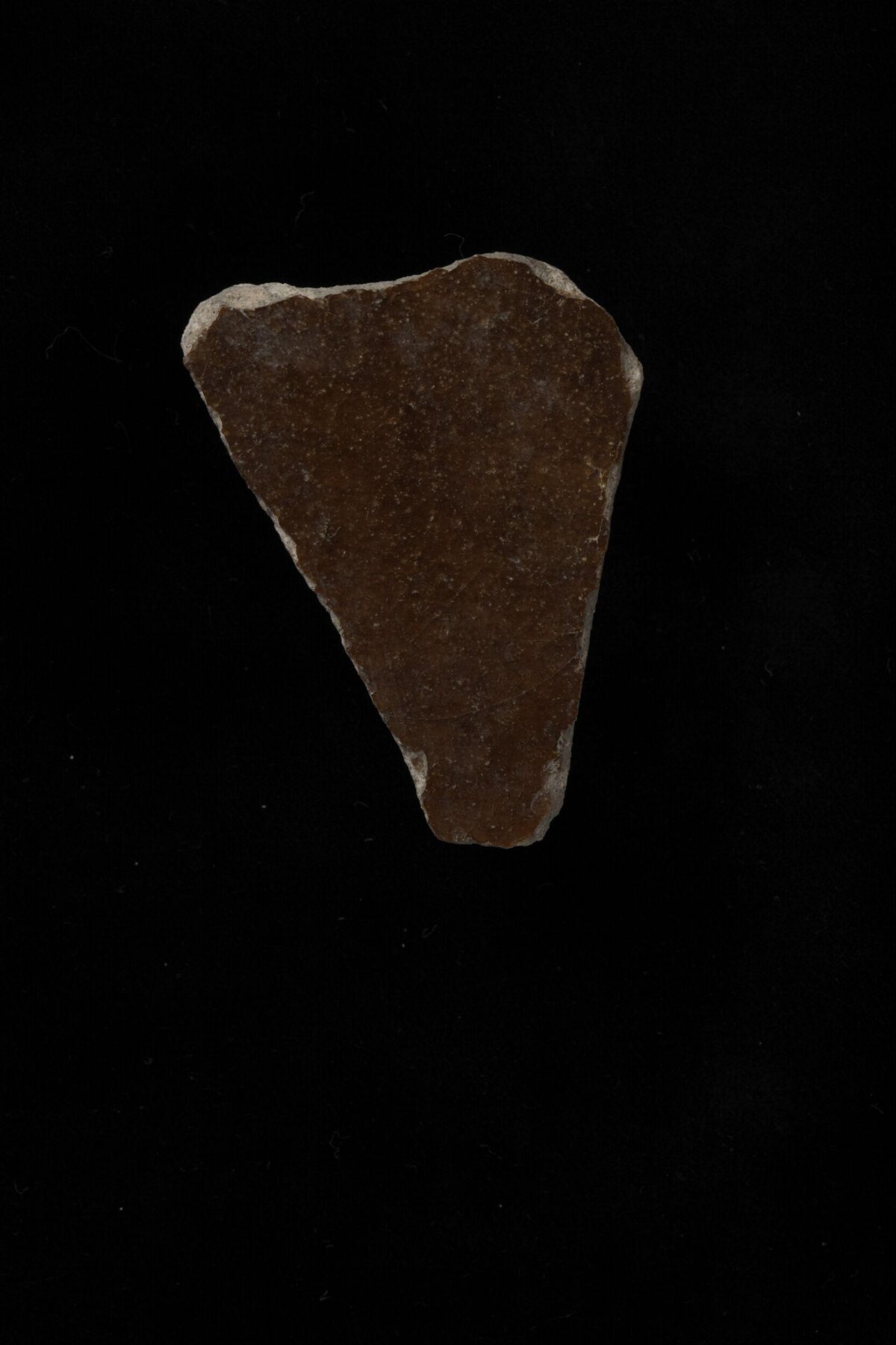 Triangular Stone Fragment on Black Background