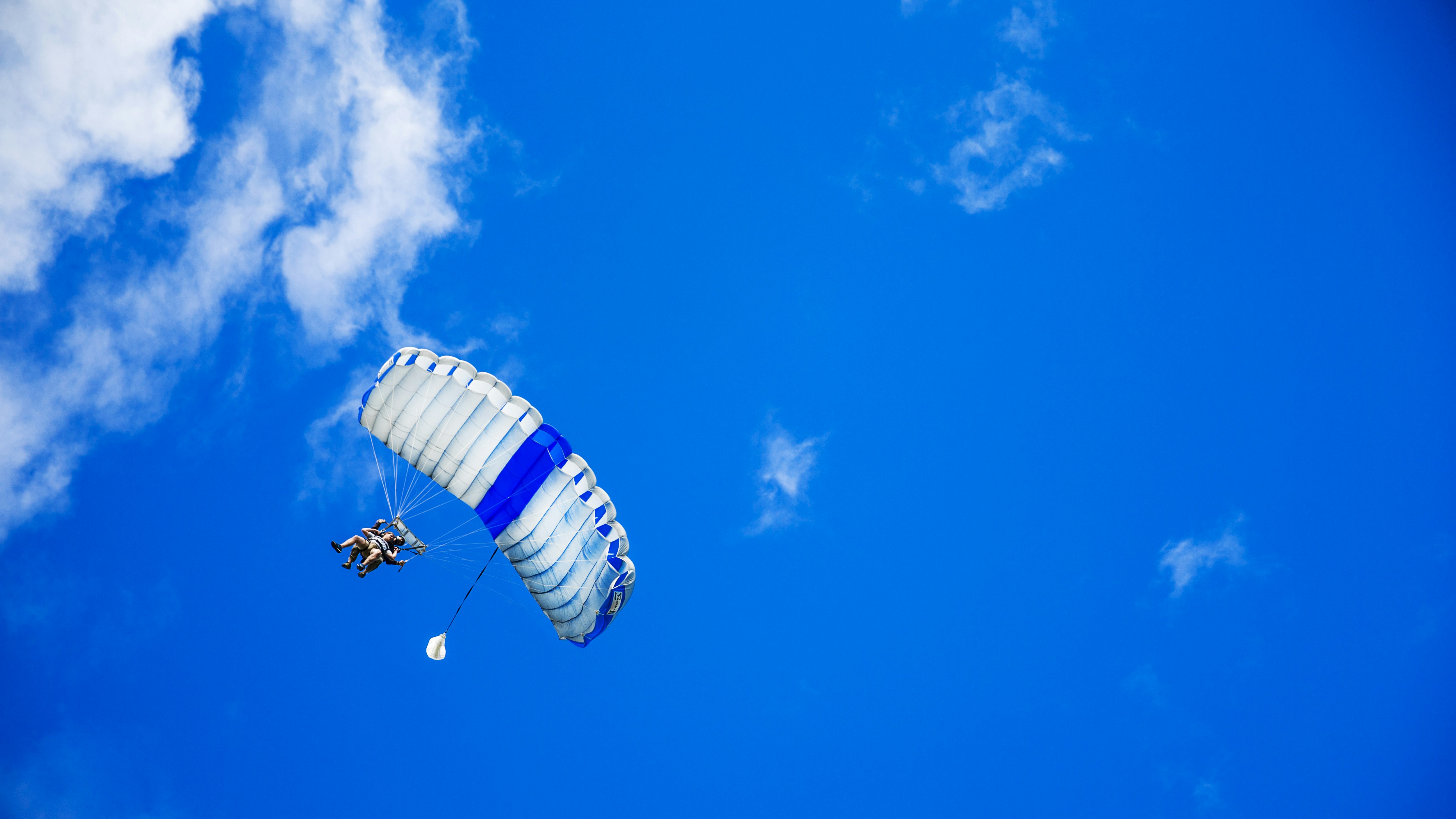 Tandem Skydiving In Bright Blue Sky