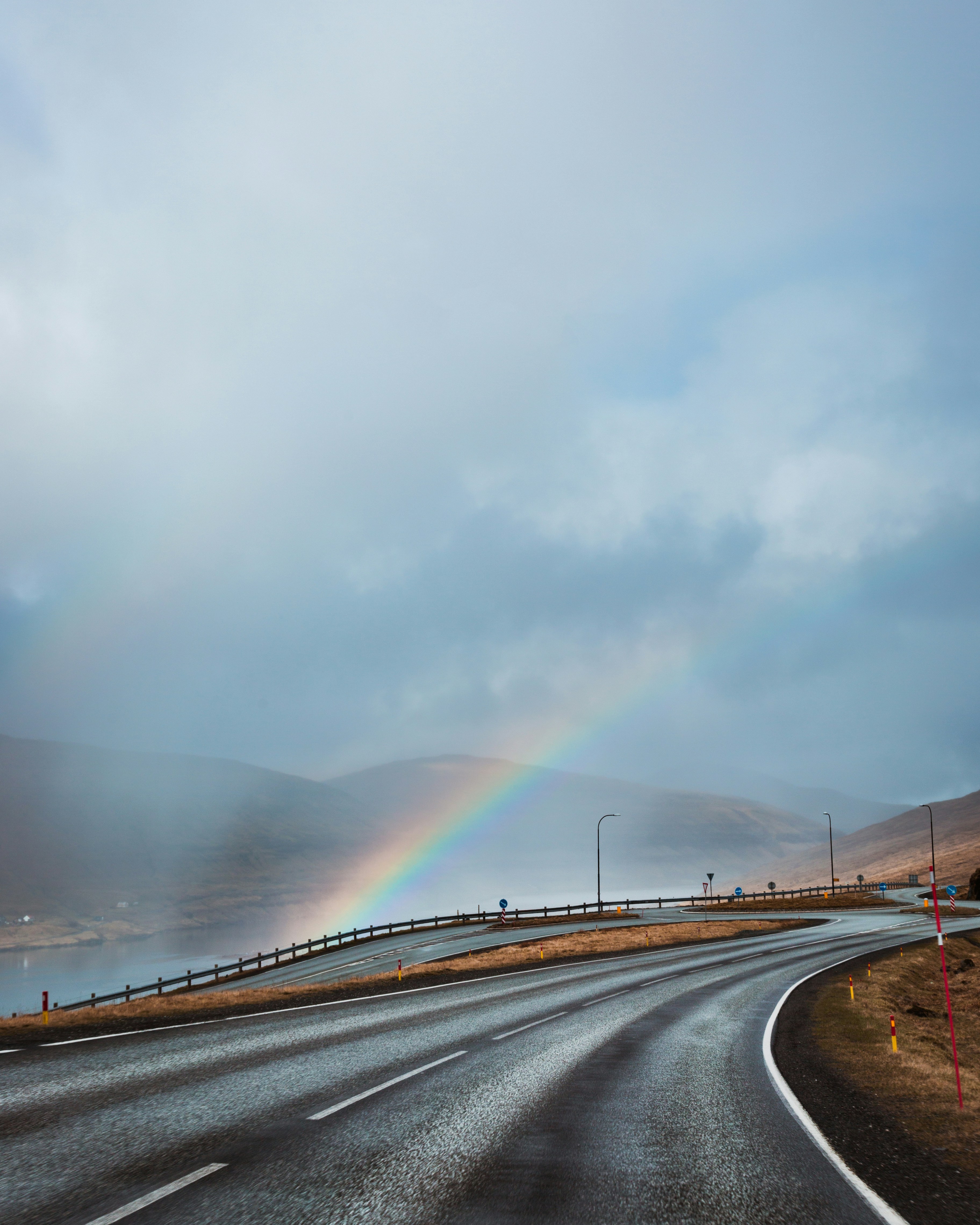Rainbow Over Winding Coastal Road