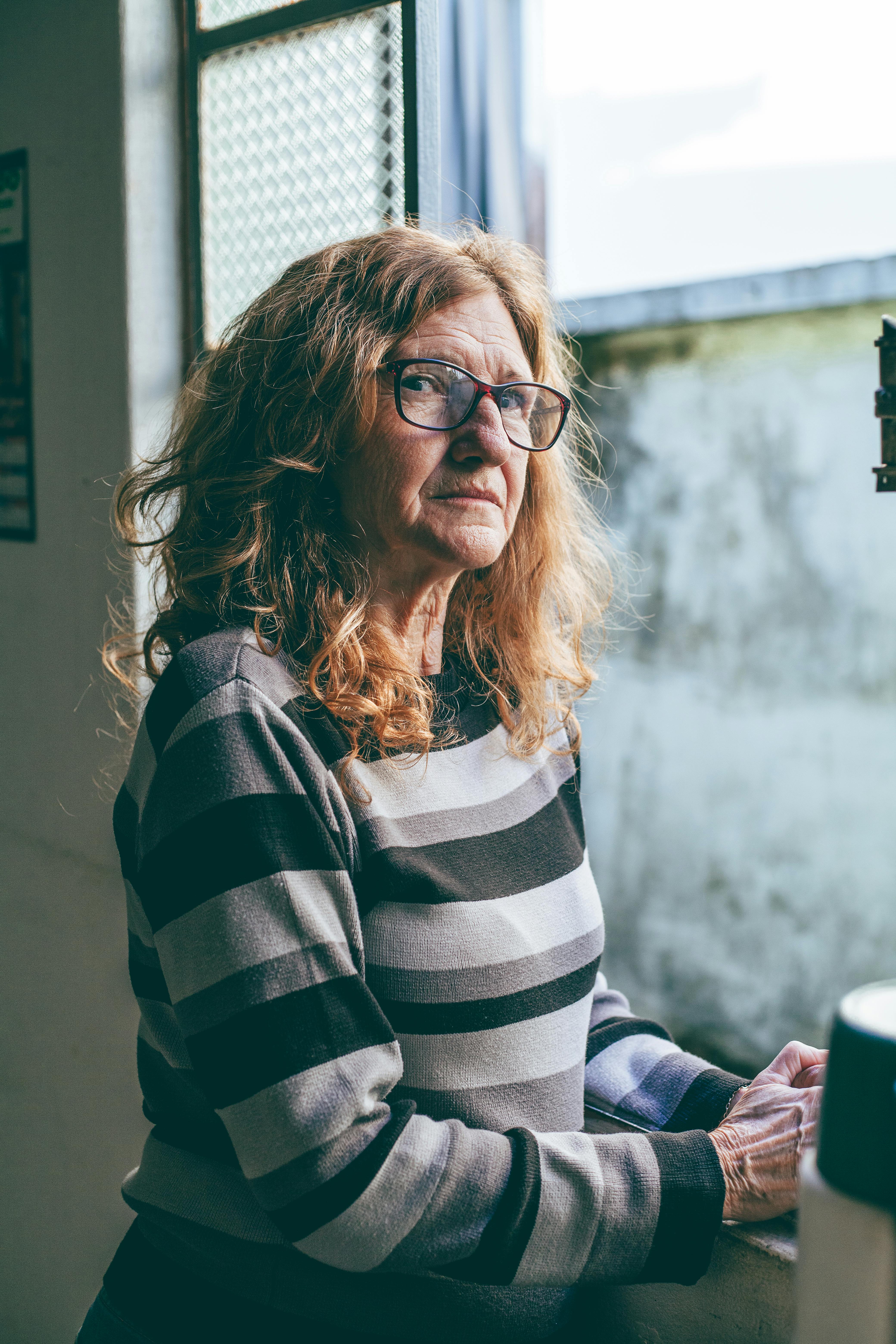 Older Woman Looking Out Window