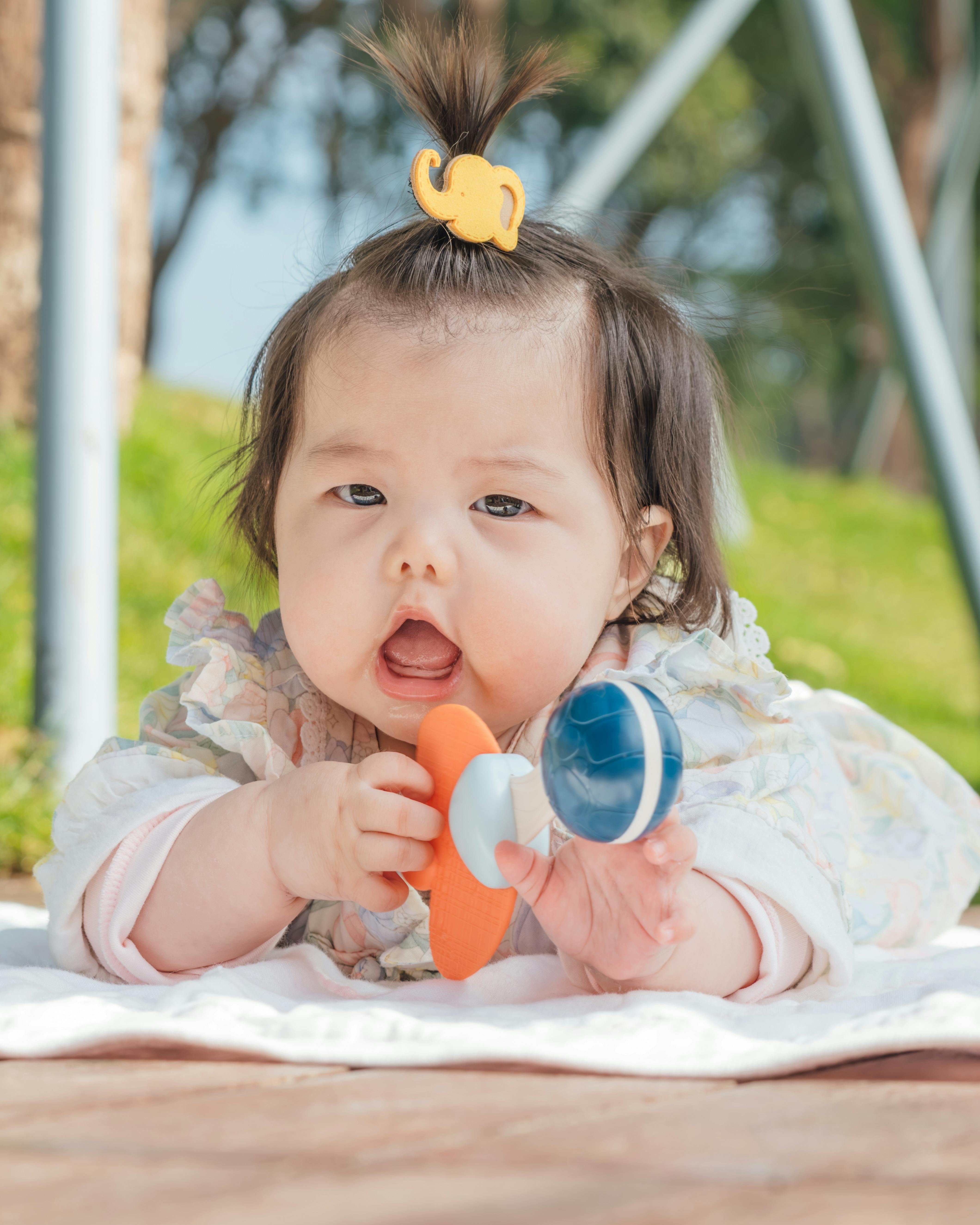 Baby Holding Toy Outdoors
