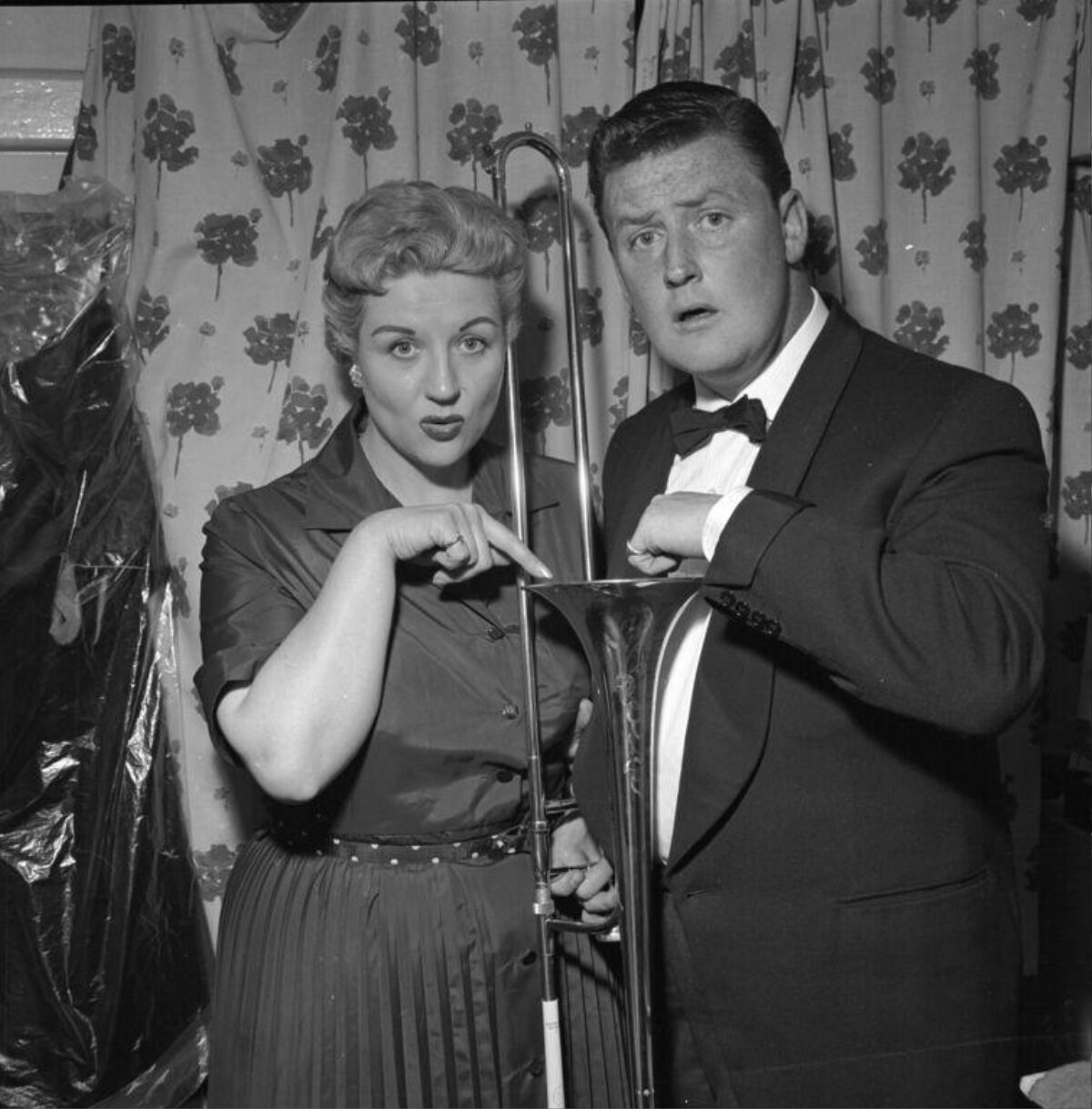 Two Performers Posing With Trombone