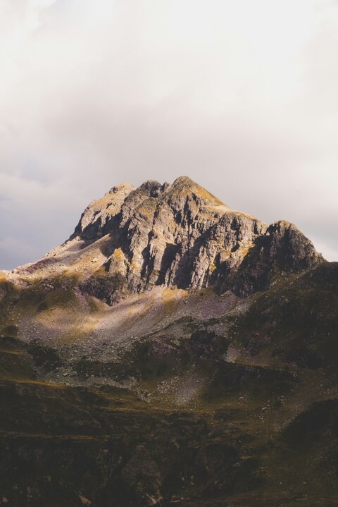 Rocky Mountain Peak Under Cloudy Sky
