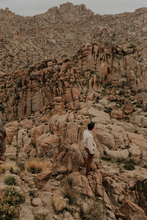 Man Standing on Rocky Desert Mountain