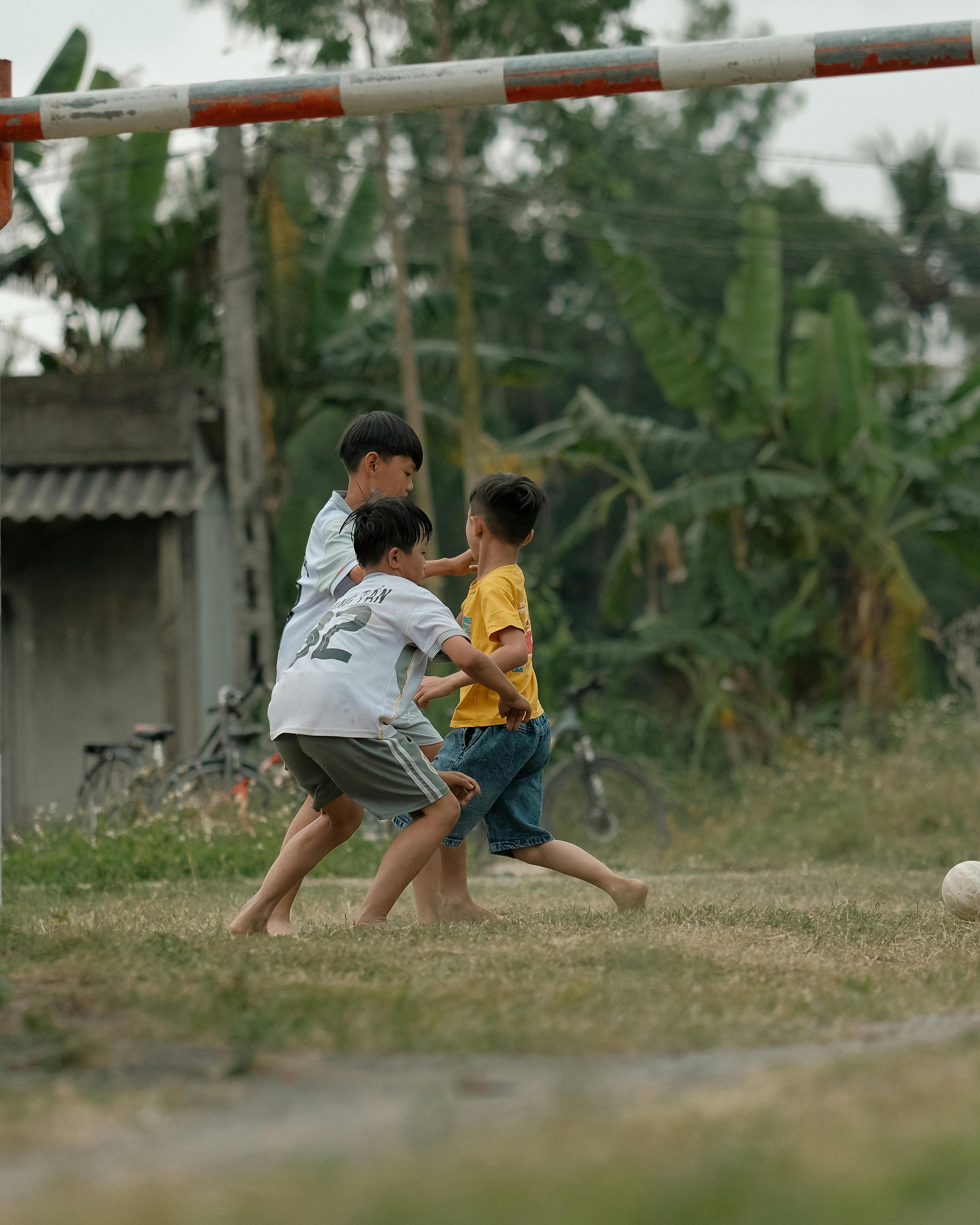 Three Boys Playing Soccer