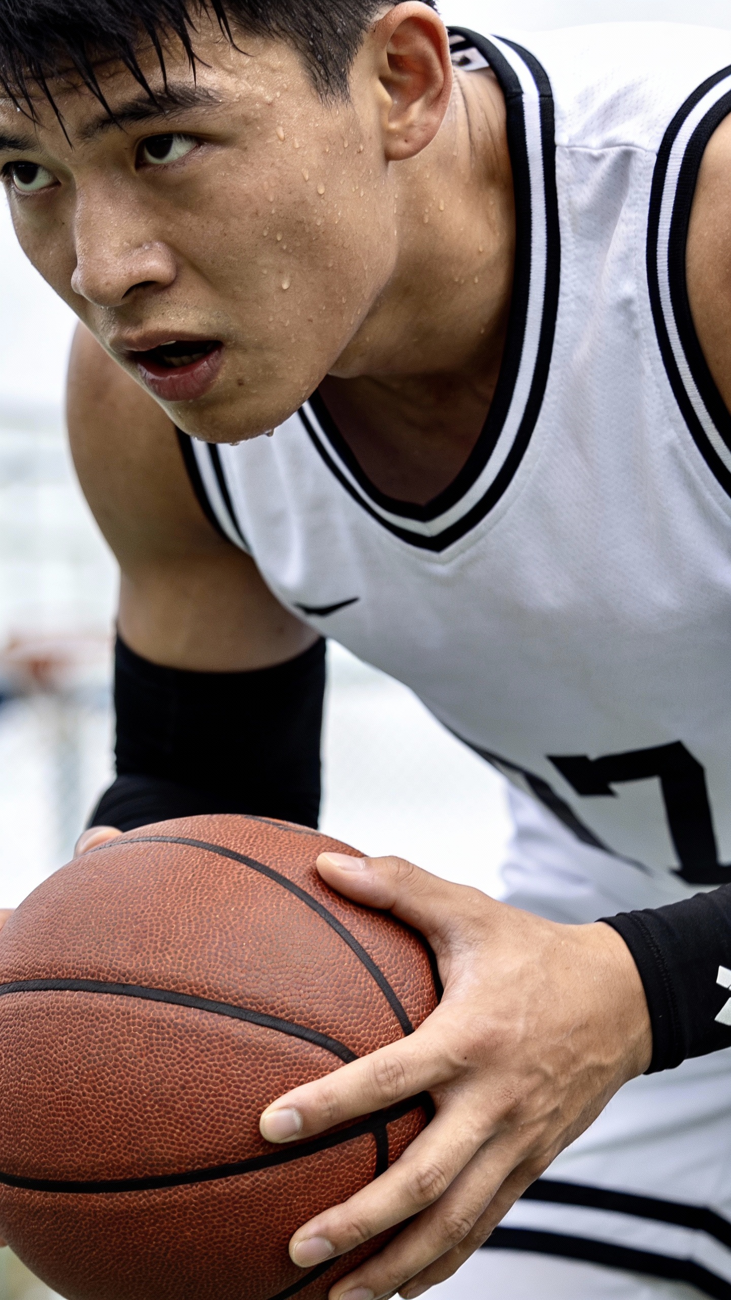 Sweaty Basketball Player Holding Basketball