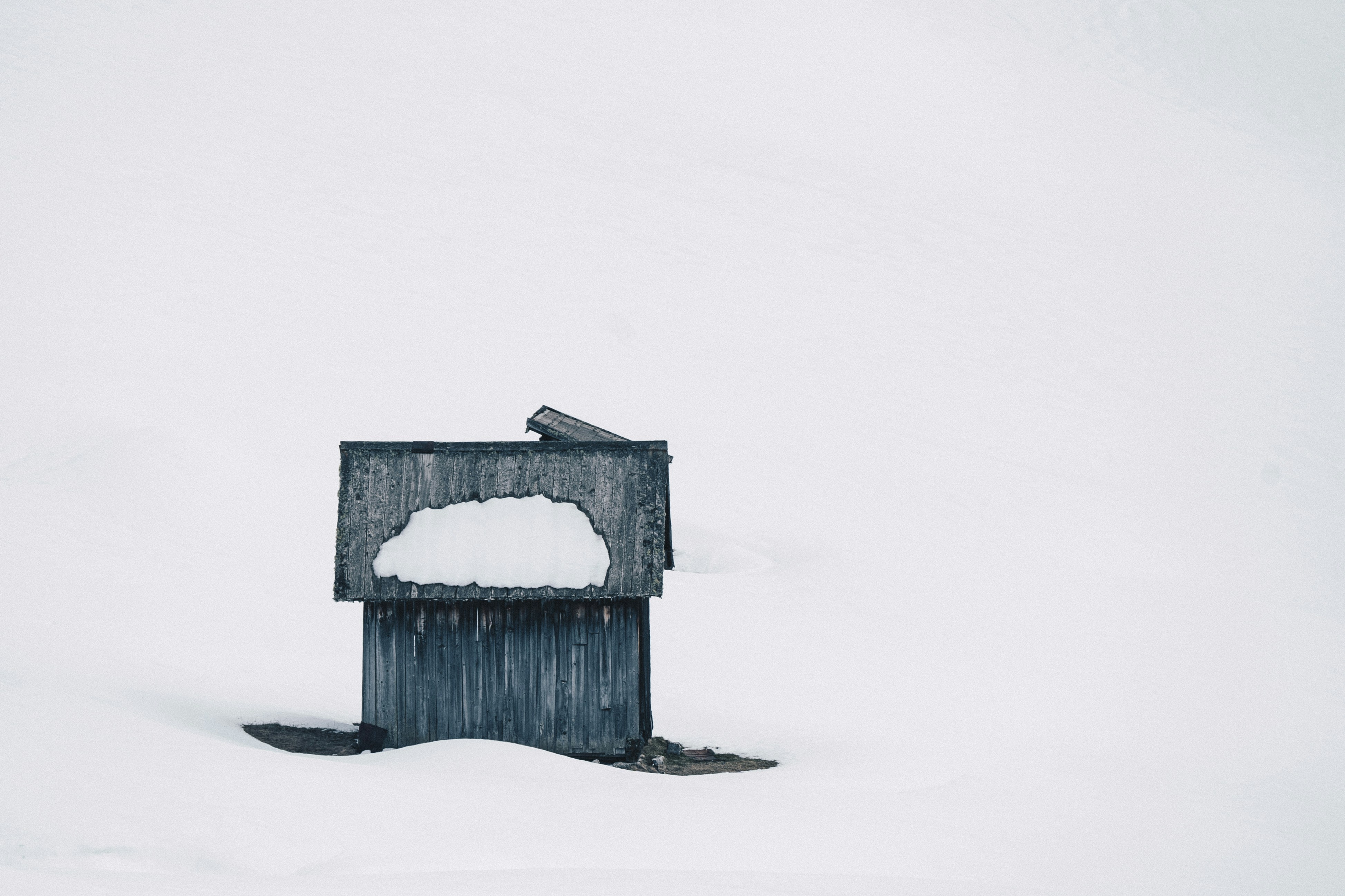 Wooden Cabin Half Buried in Snow