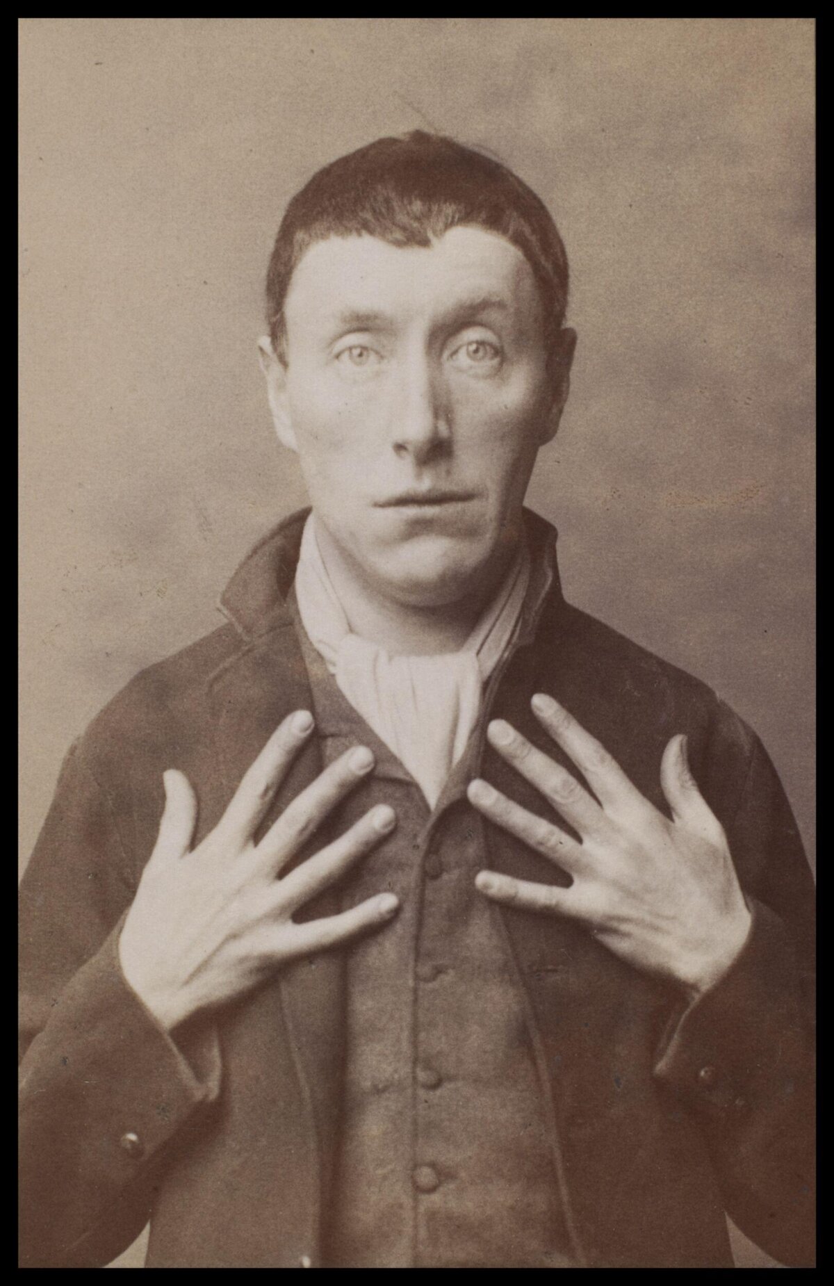 Vintage Portrait of Man with Hands on Chest