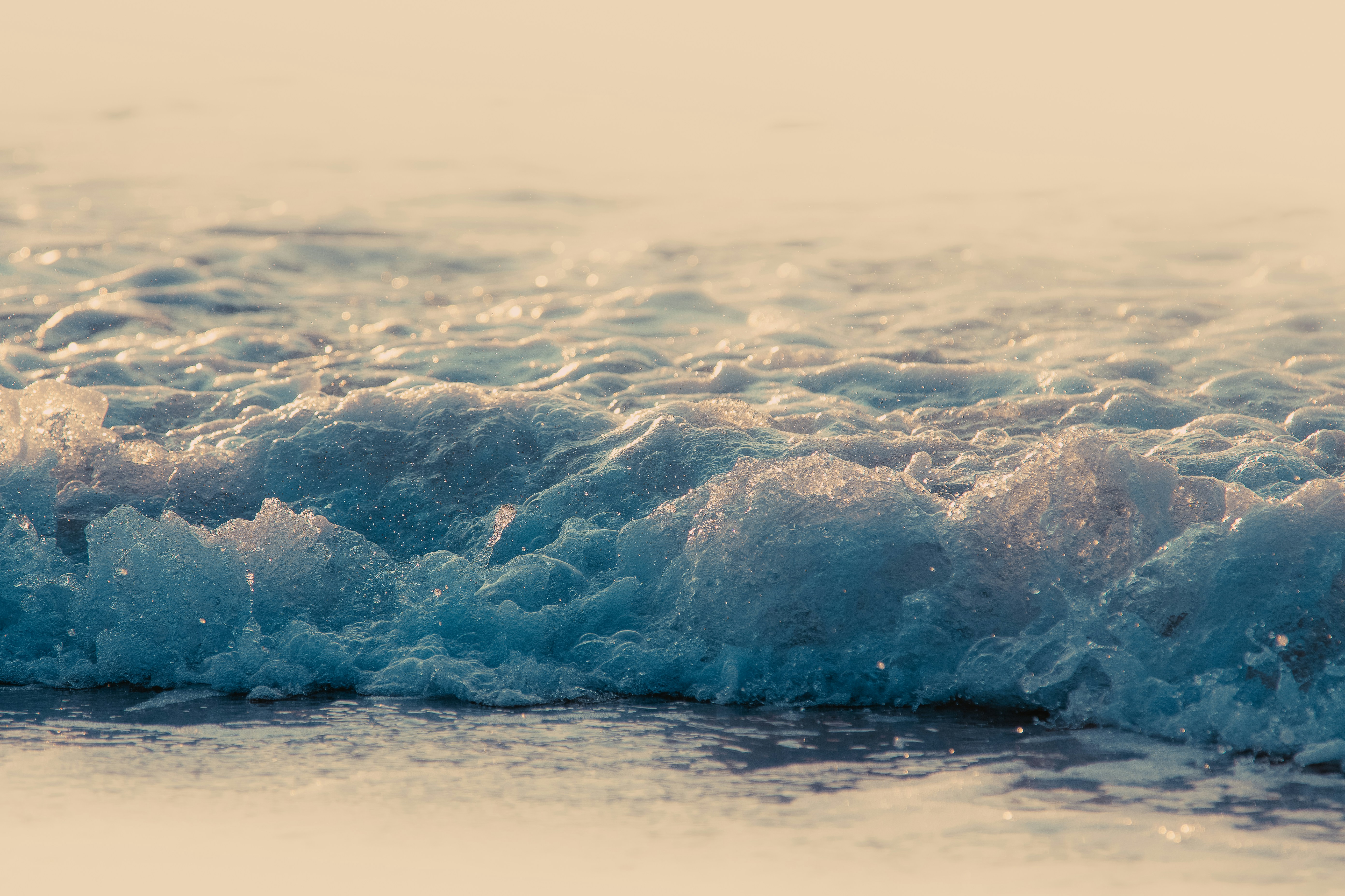 Sunlit Breaking Wave on Beach