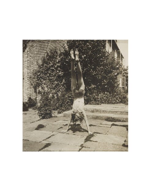 Woman Doing Handstand in Vintage Garden
