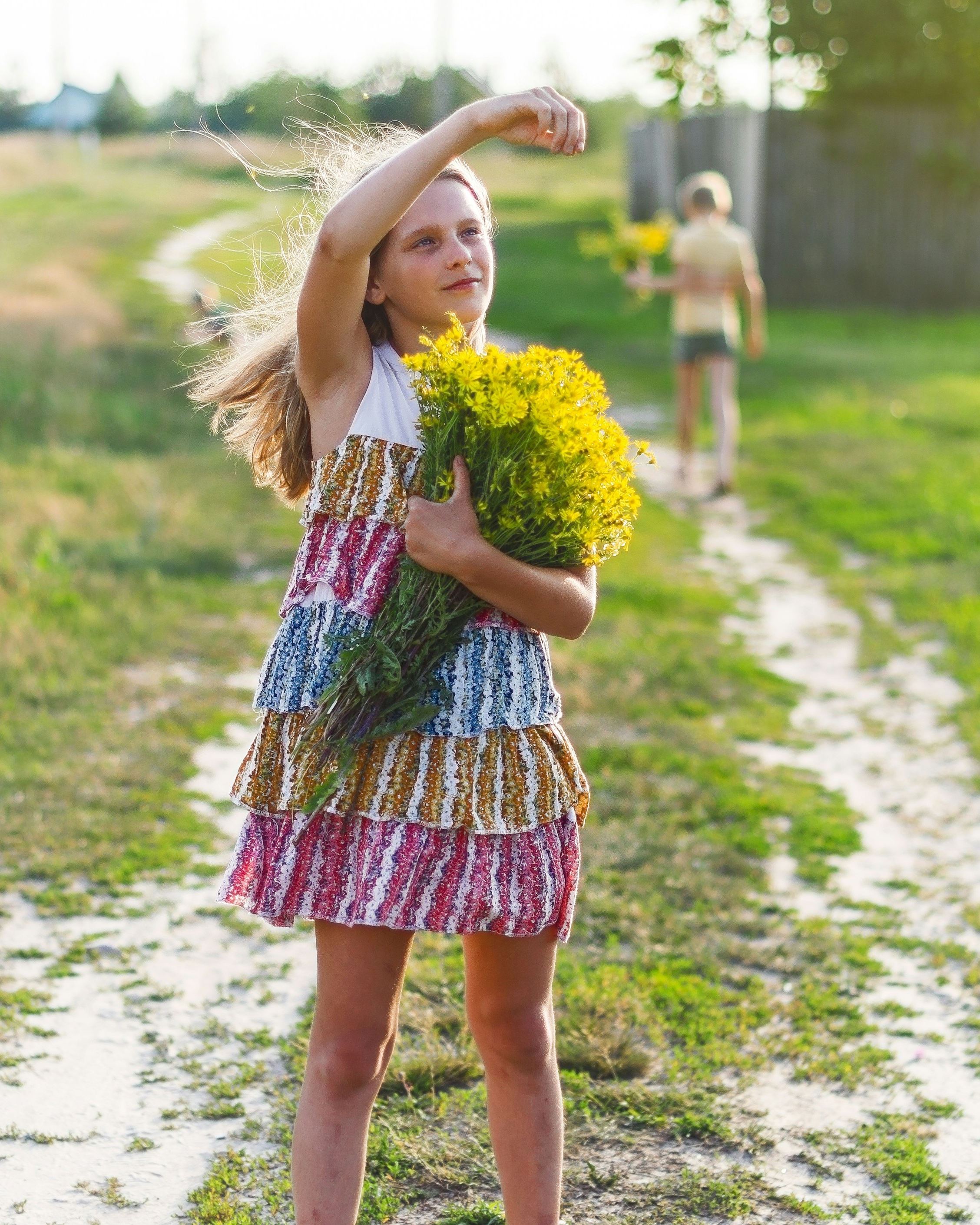 Girl With Yellow Wildflowers on Country Path