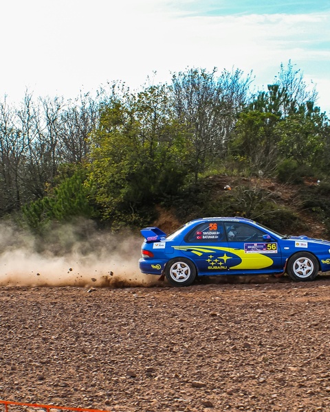Blue Subaru Rally Car on Dirt Track