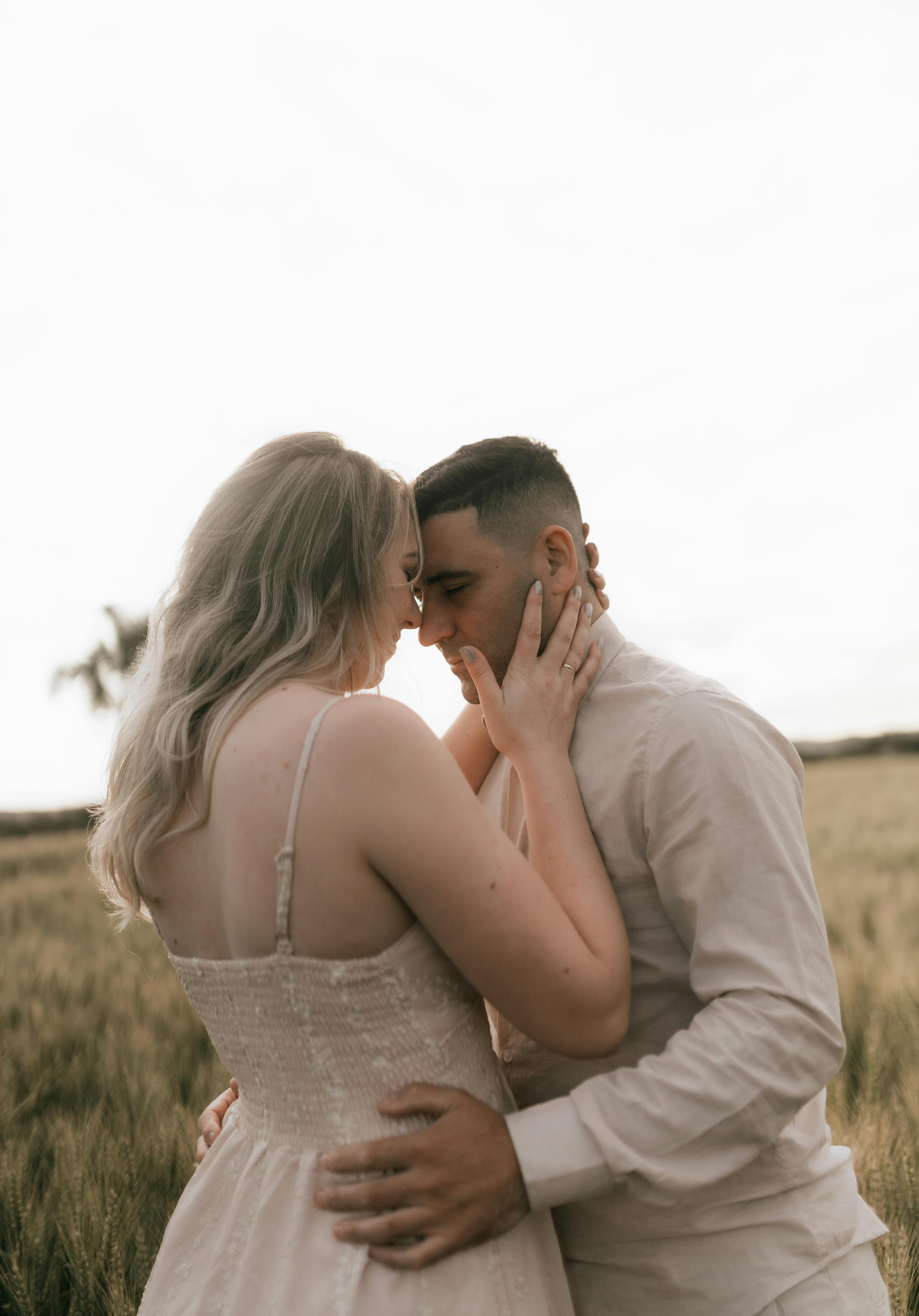 Couple Embracing In Golden Field