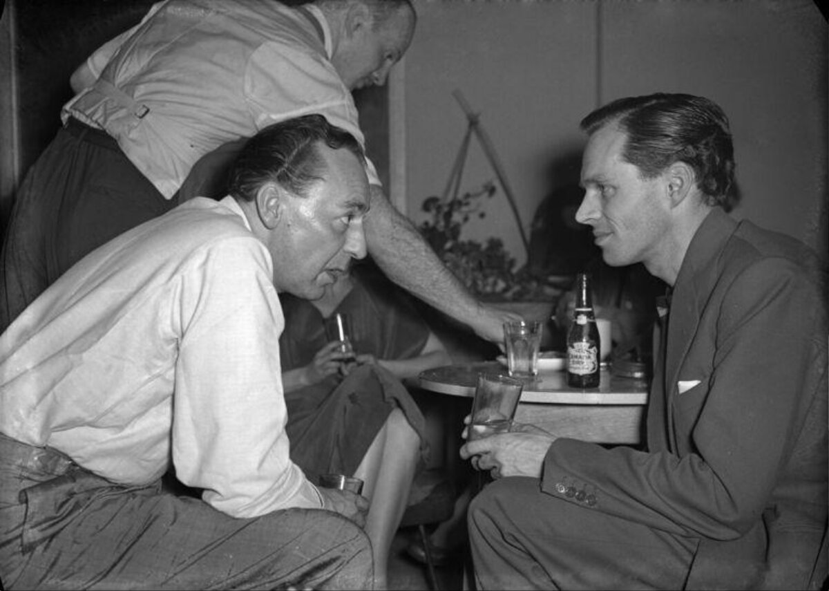 Two Men Chatting Over Drinks