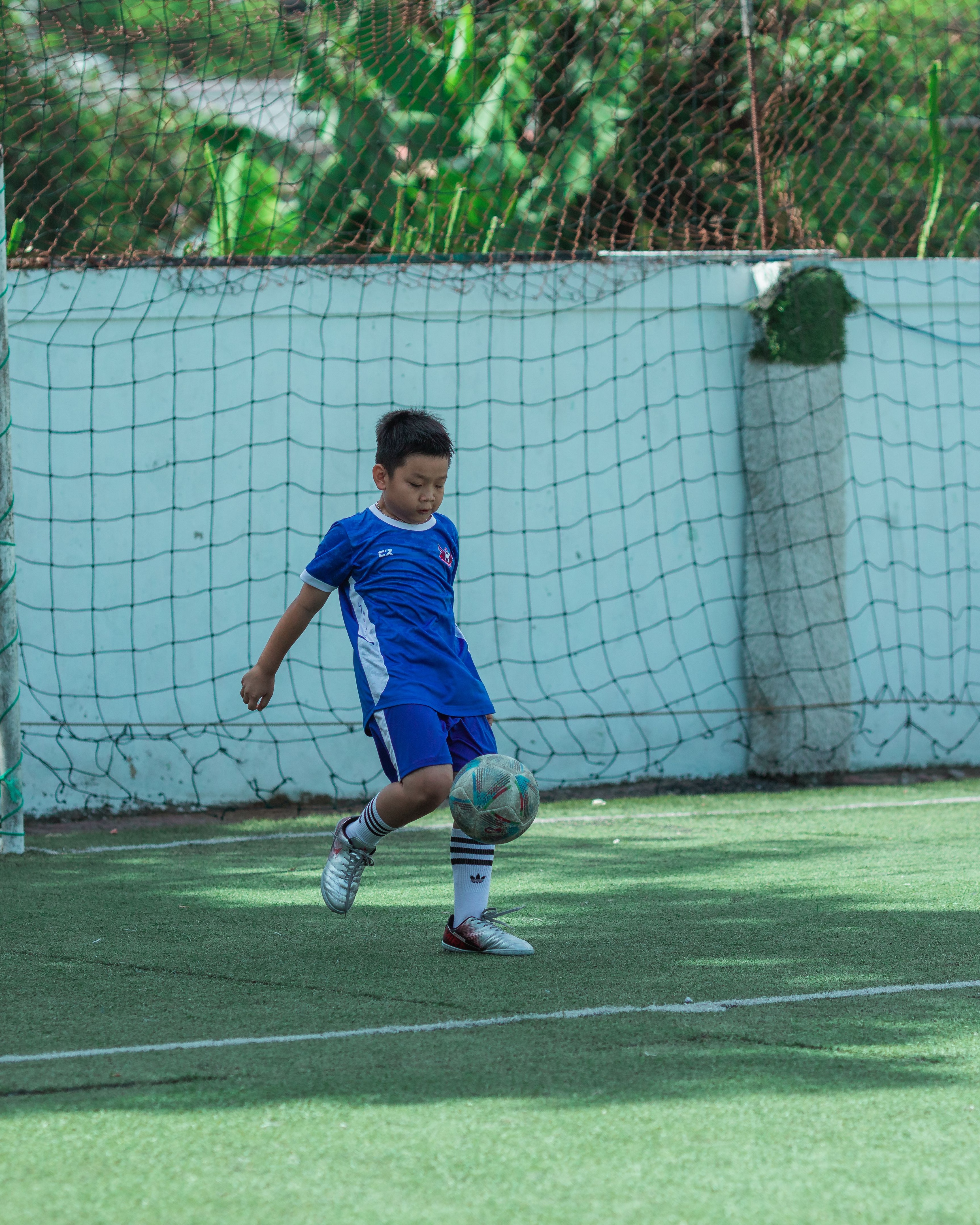 Young Boy Practicing Soccer