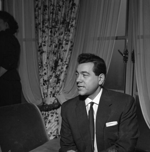 Seated Man in Formal Suit