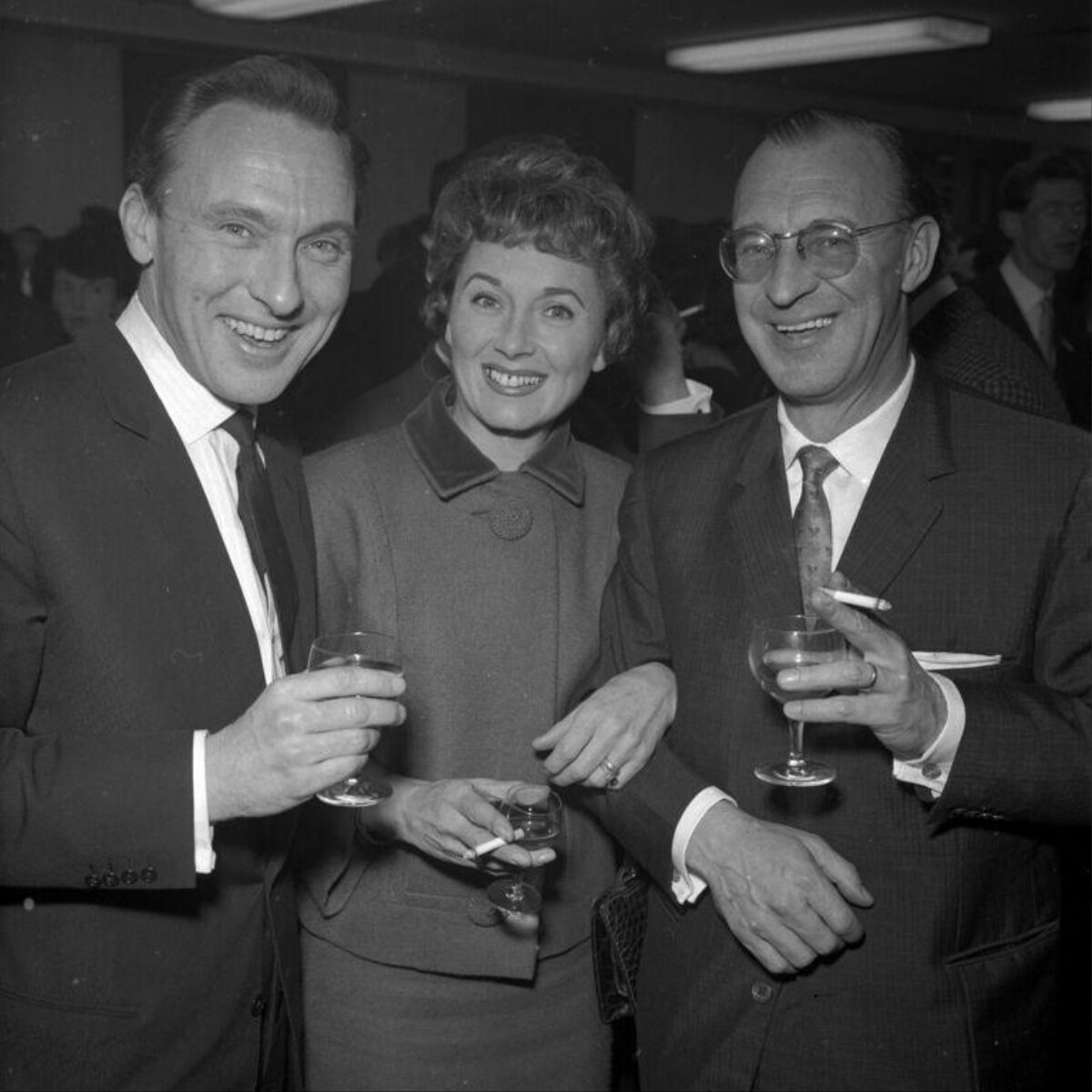 Three People Toasting at a Social Gathering