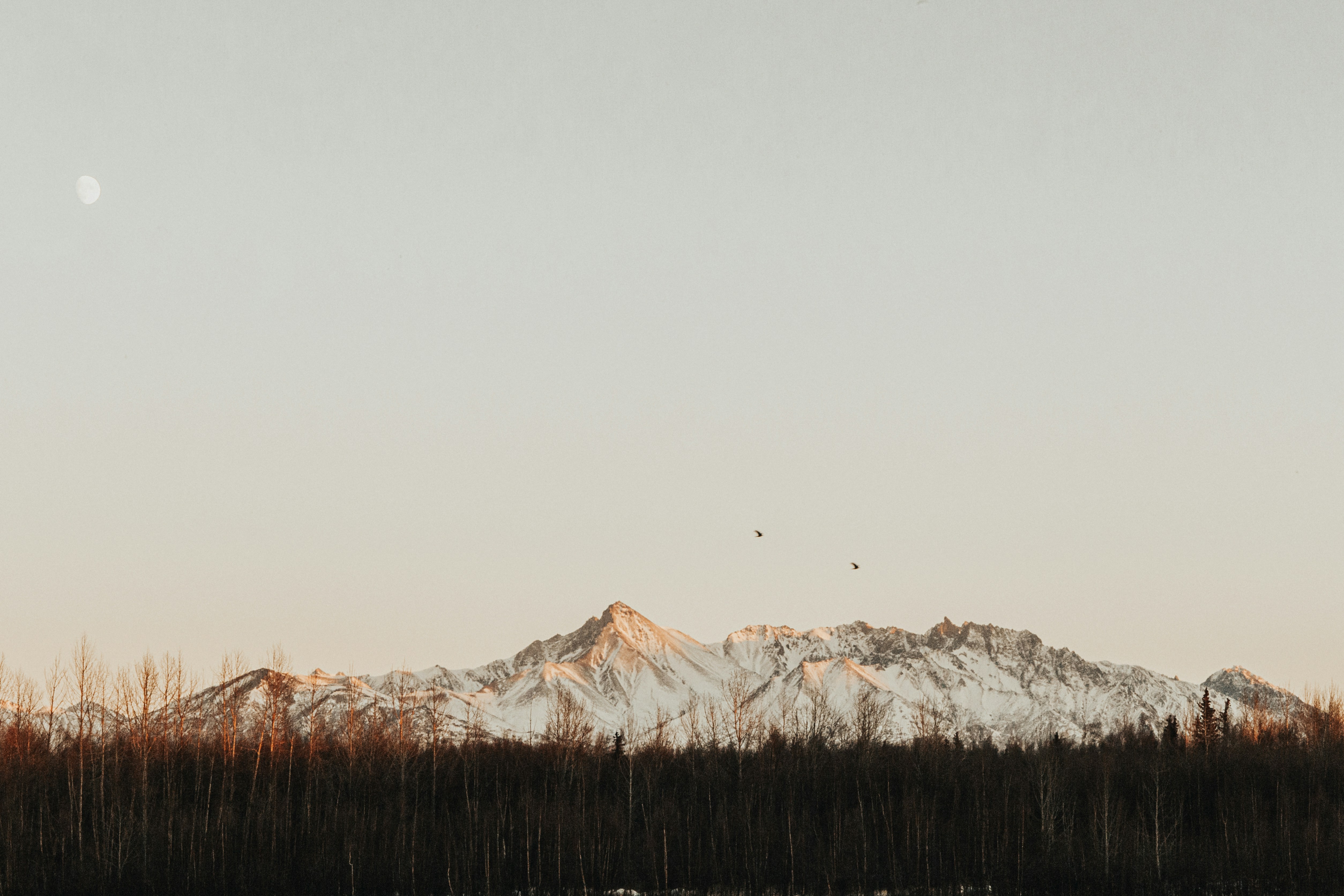 Moon Over Snow-capped Mountains