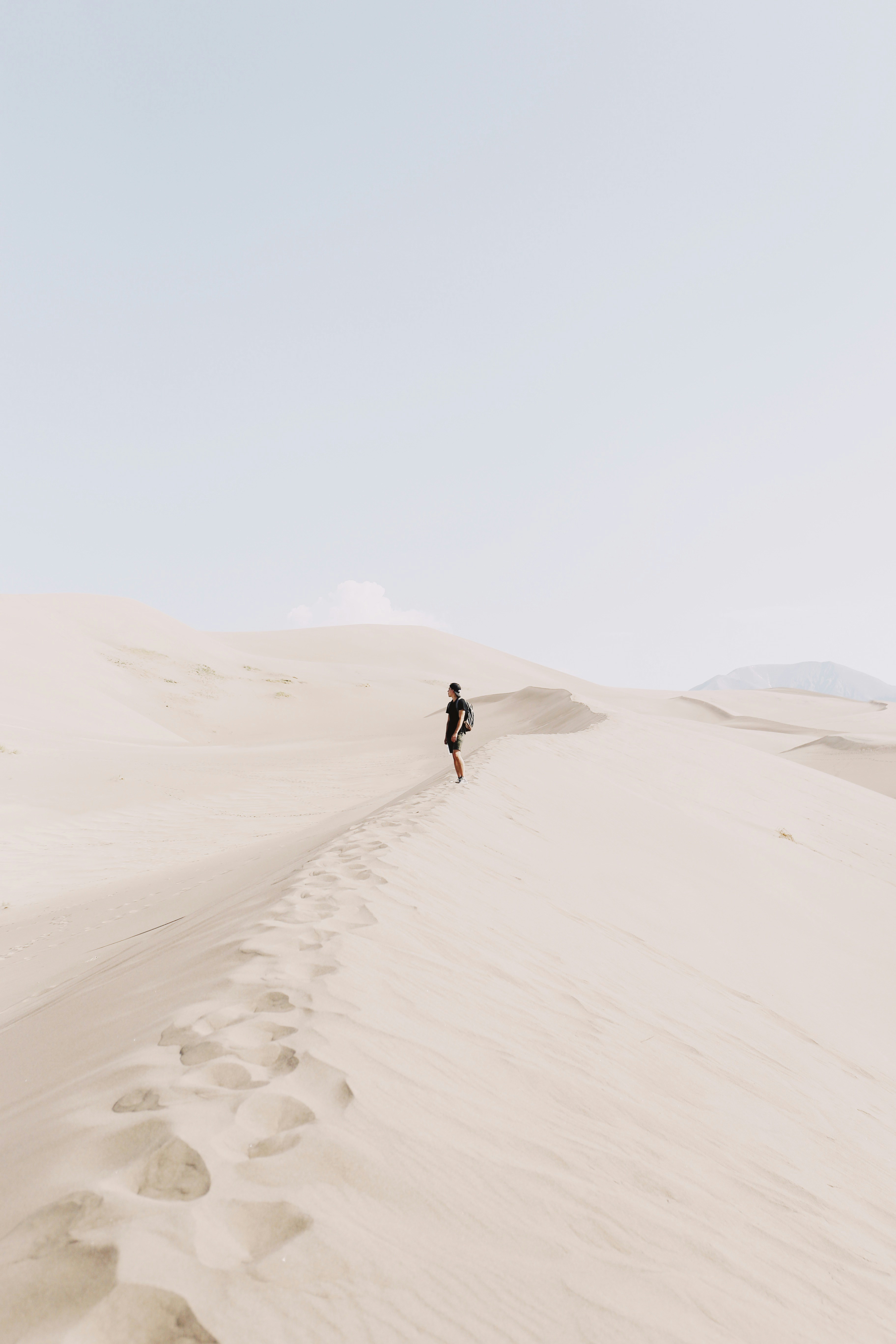 Hiker Standing on Desert Sand Dunes