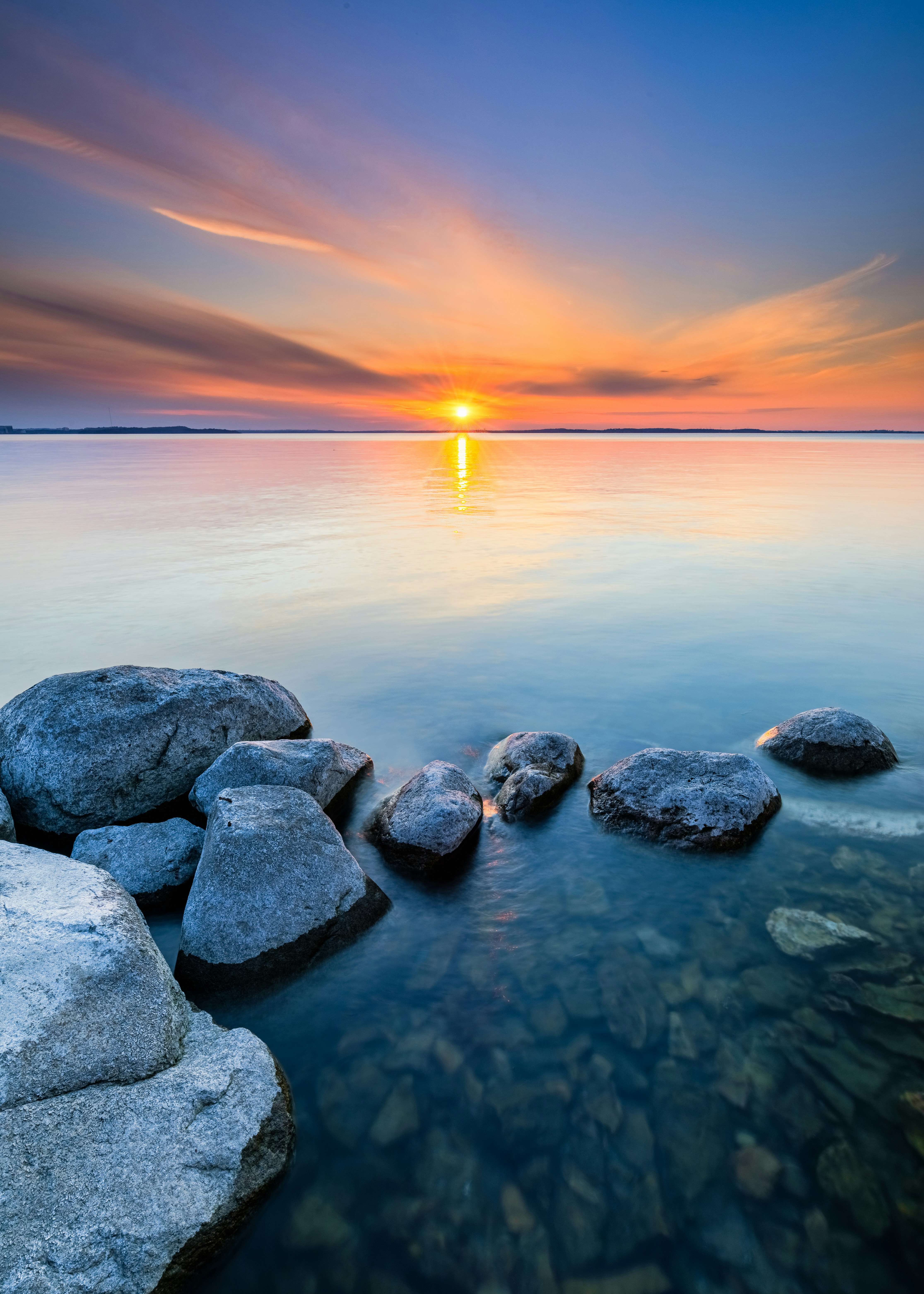 Sunset Over Rocky Lake Shore