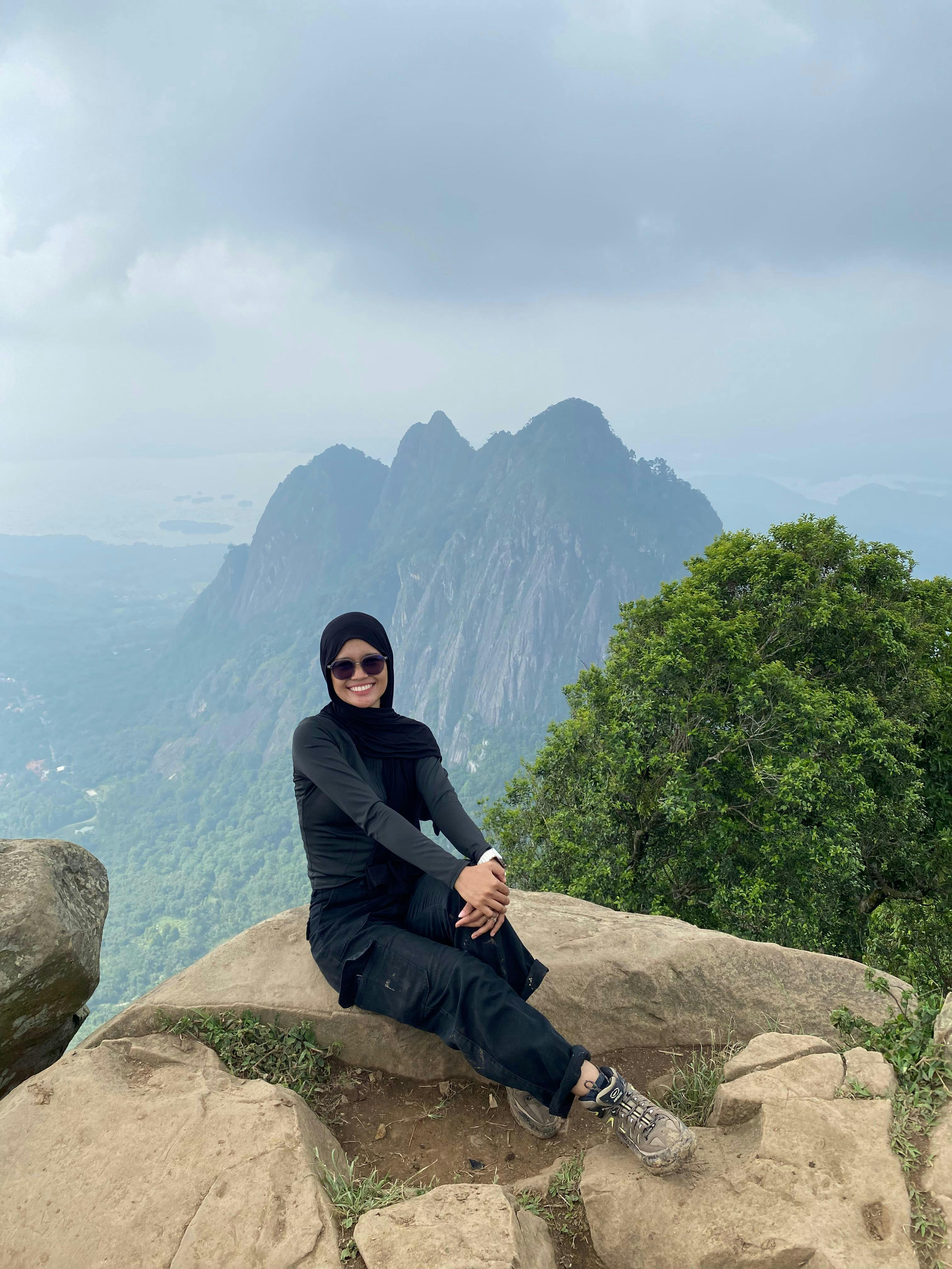 Hiker Resting on Mountain Peak