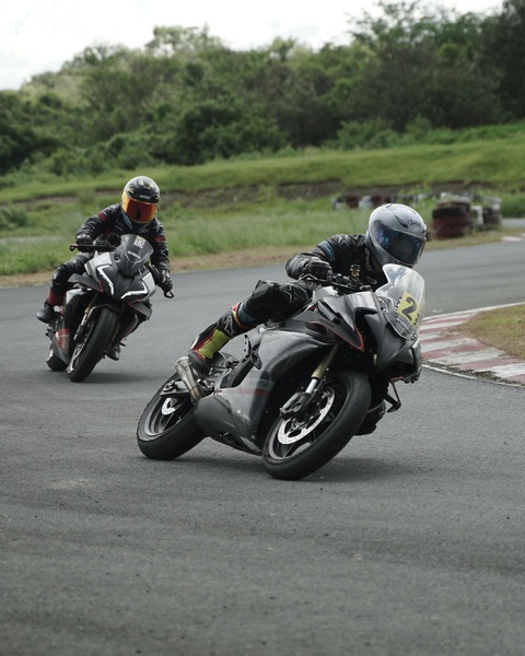 Two Motorcyclists Cornering on Race Track