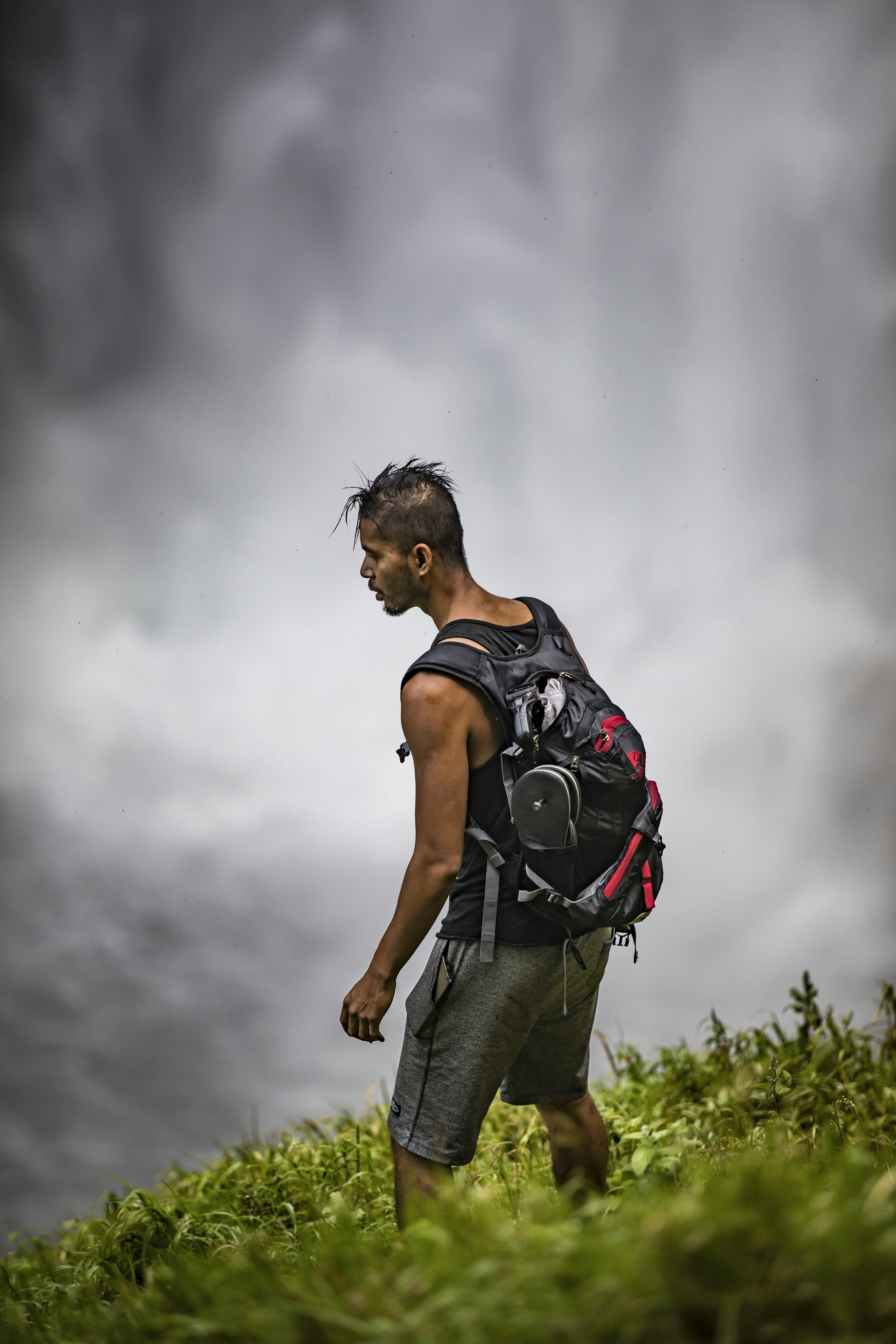 Hiker Standing on Grassy Hillside