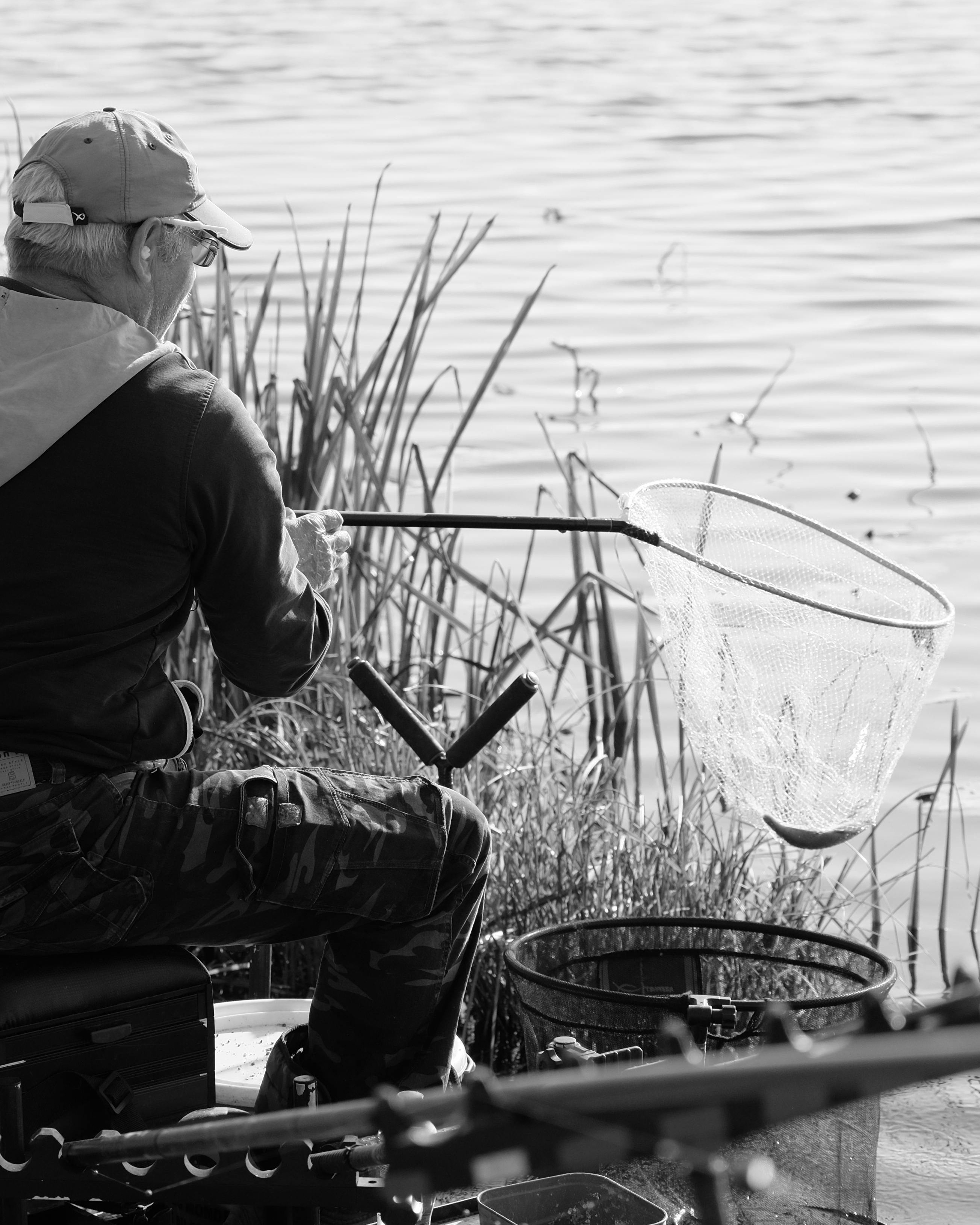 Fisherman Fishing by Calm Lake