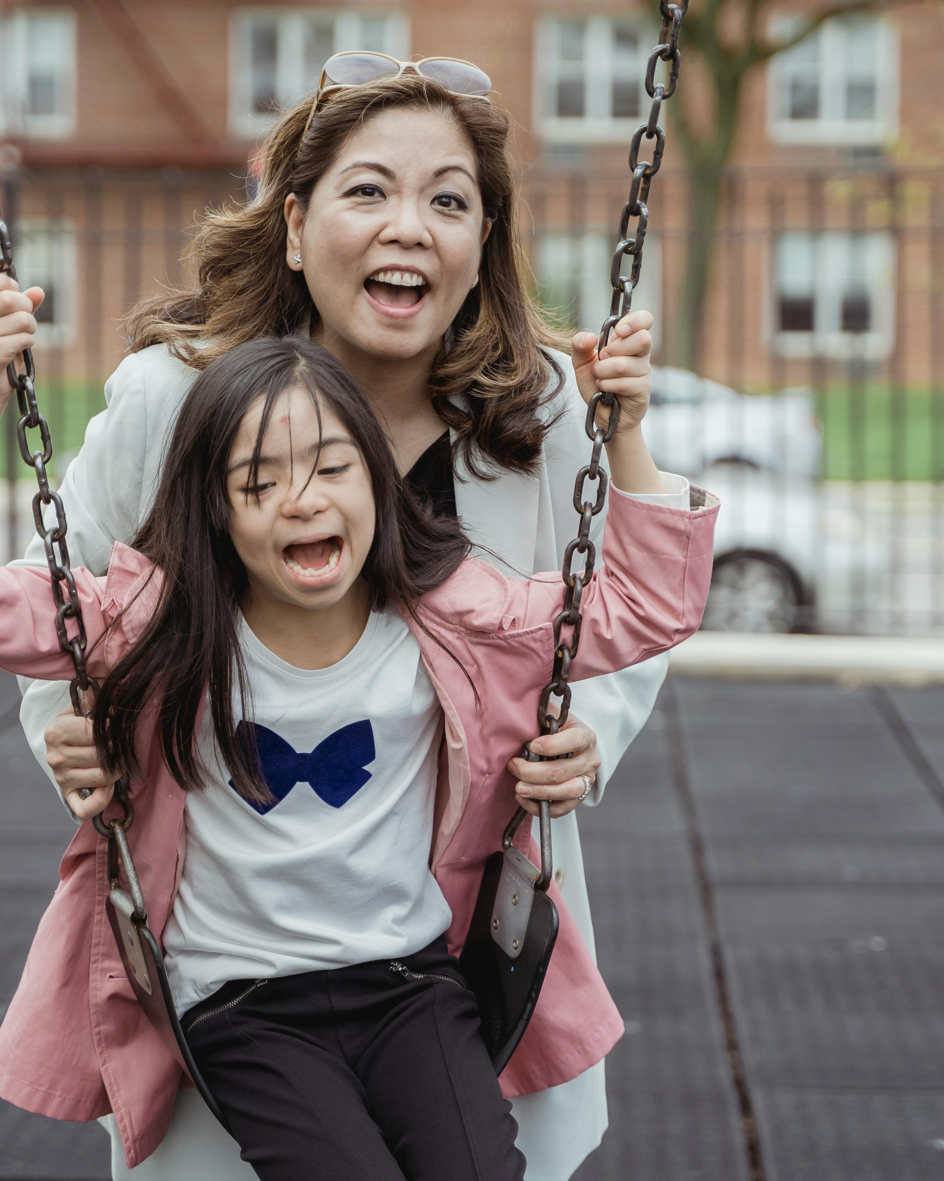 Mother and Daughter on Playground Swing