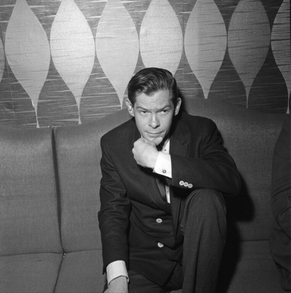 Man In Suit Seated On Couch