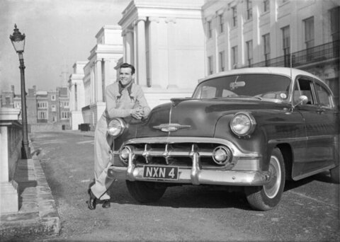 Man Leaning On Vintage Car