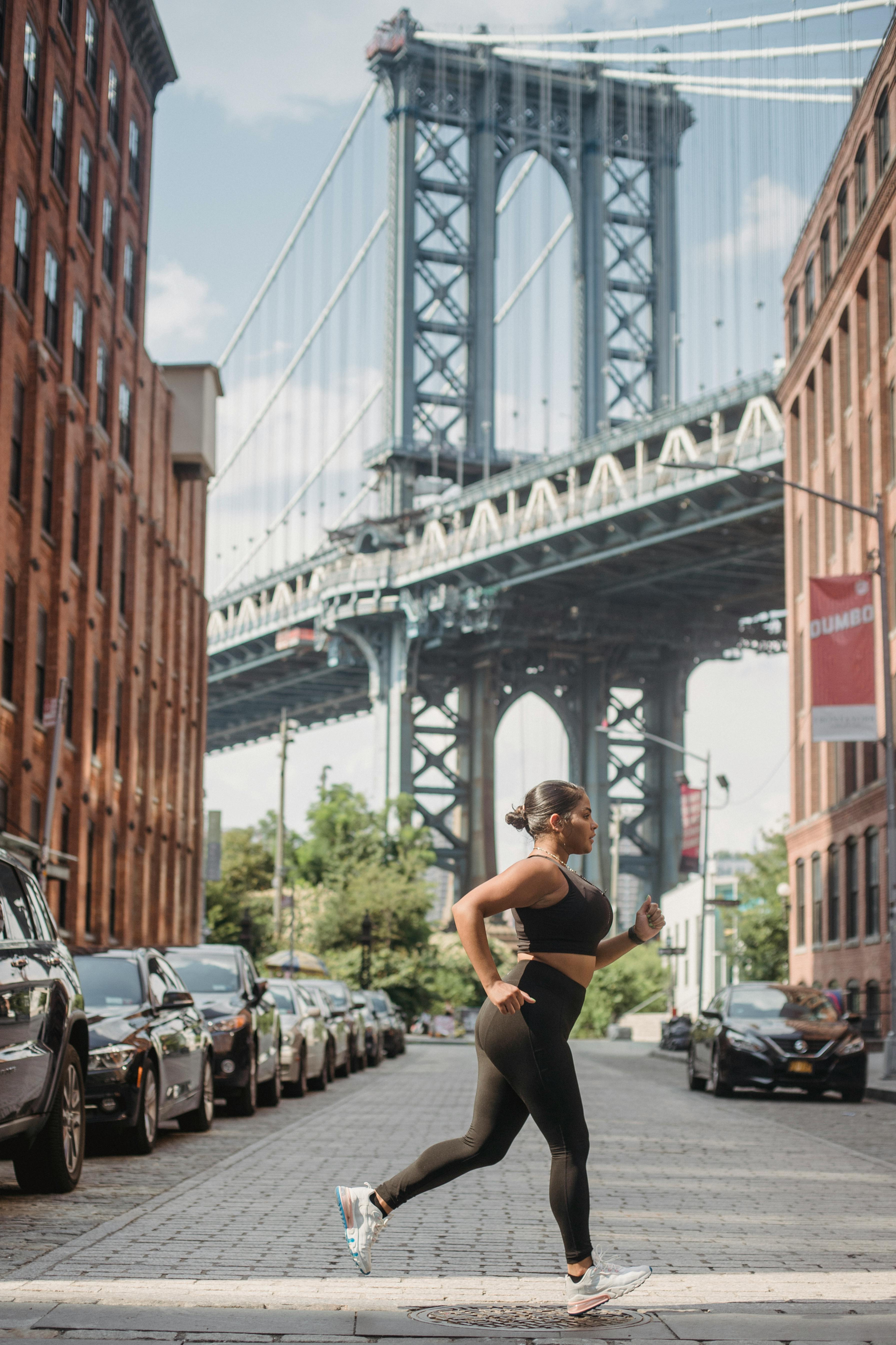Woman Jogging by Manhattan Bridge