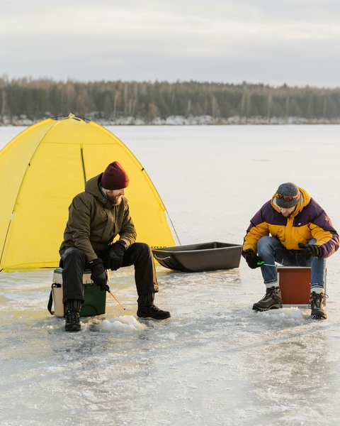 Two Men Ice Fishing on Frozen Lake