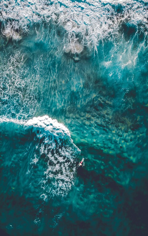 Aerial View of Surfer in Ocean Waves