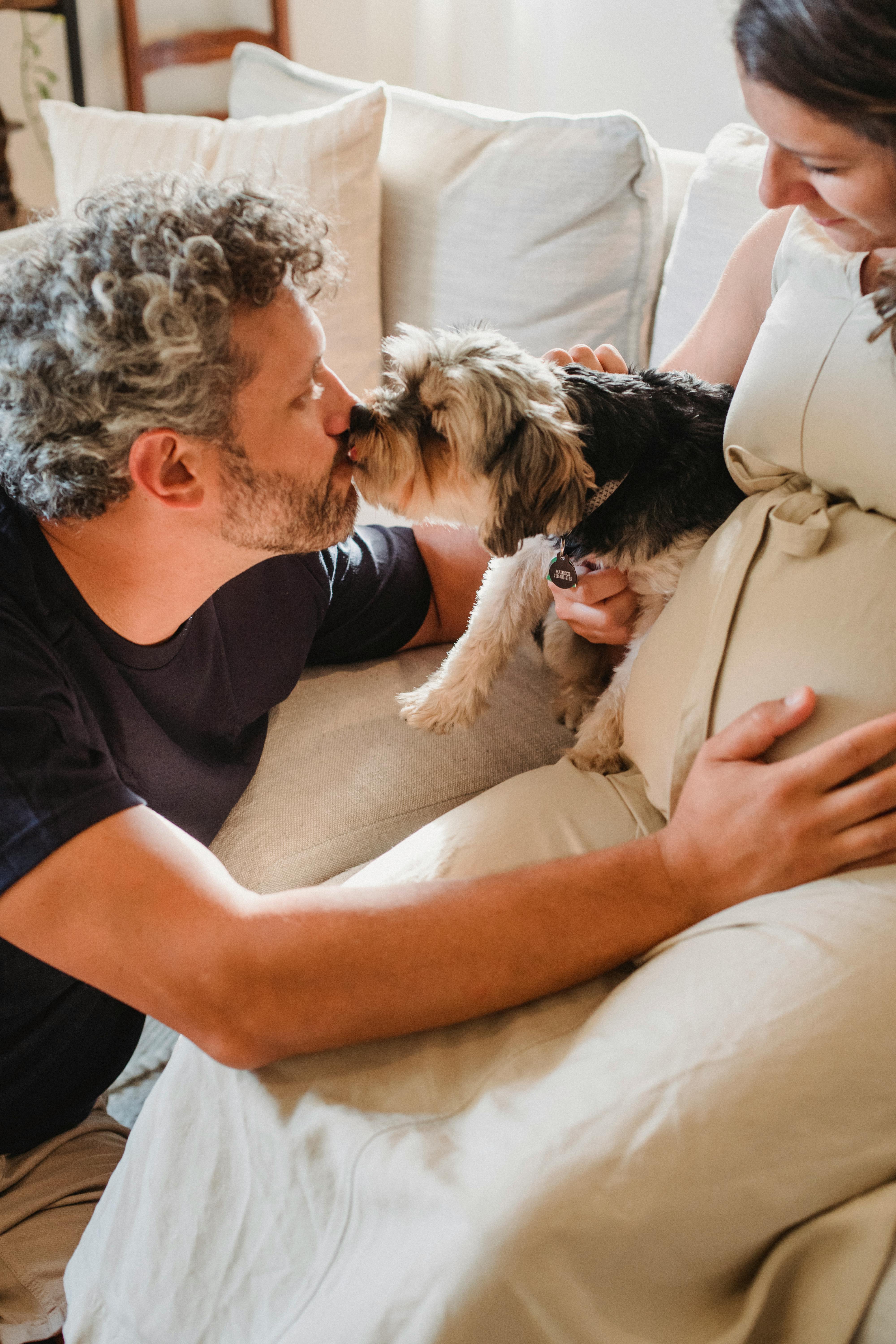 Expecting Couple With Pet Dog At Home