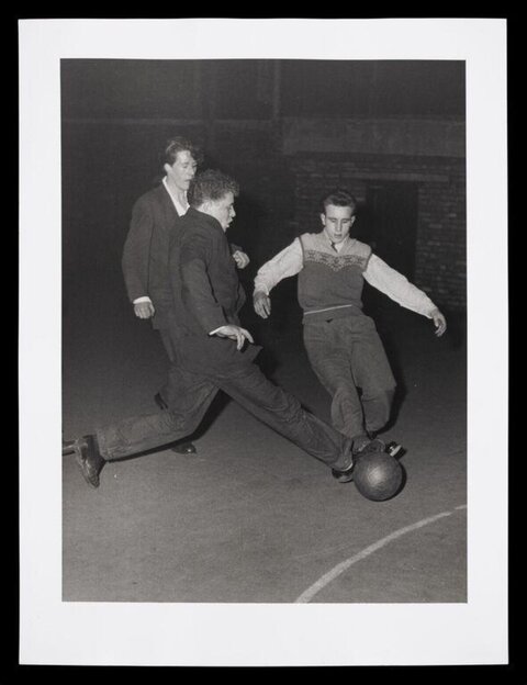 Three Young Men Playing Football
