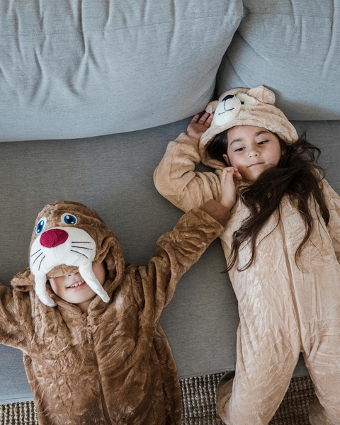 Two Children in Animal Onesies on Sofa