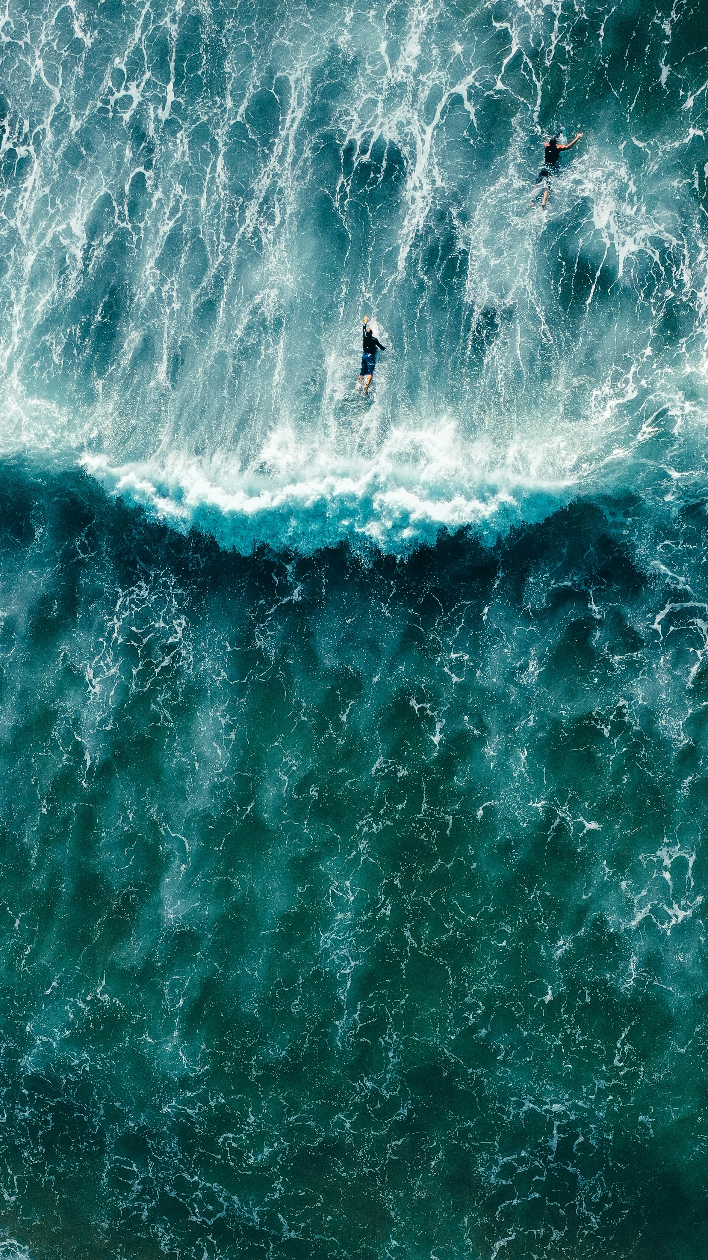 Aerial View of Two Surfers in Ocean