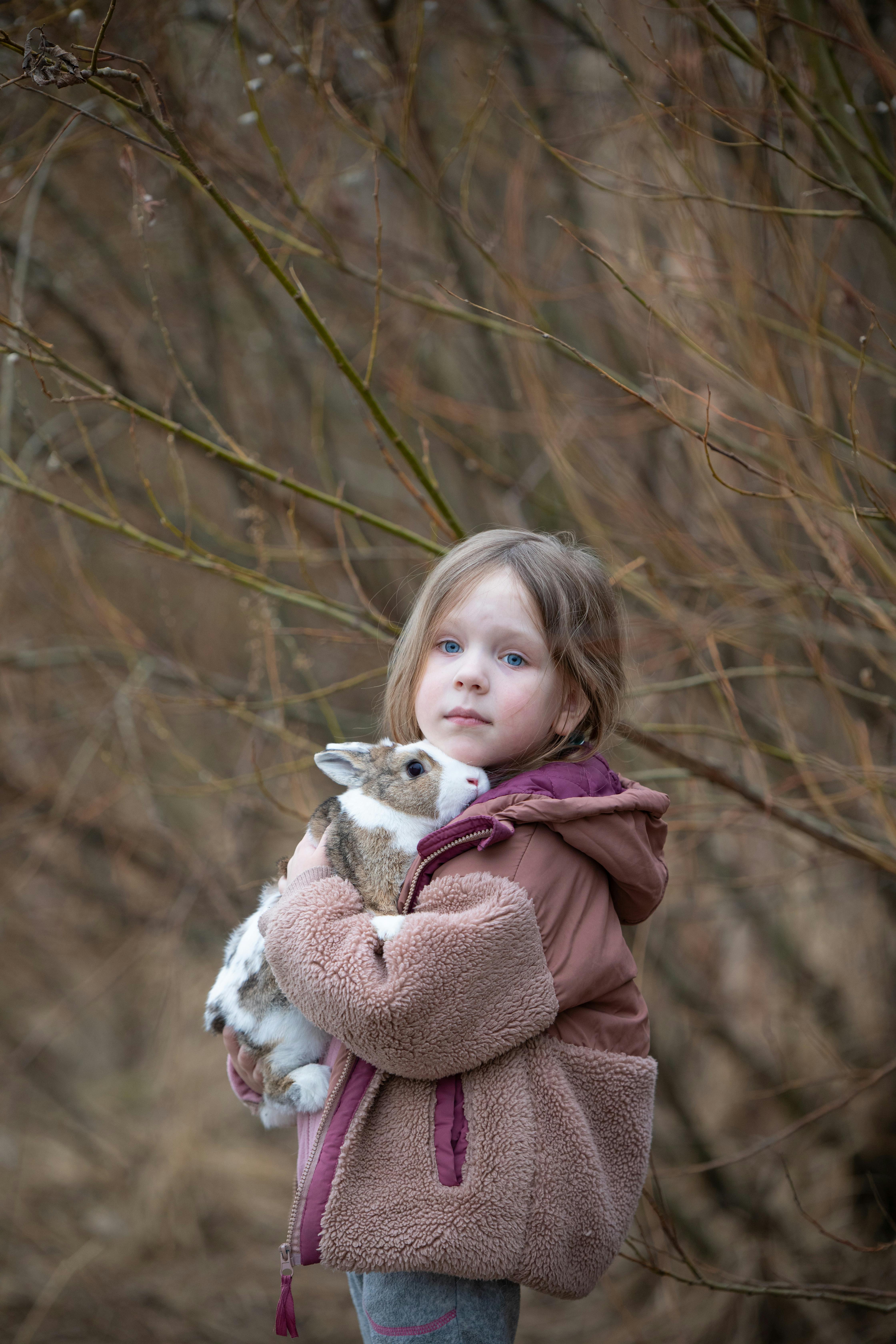 Girl Holding Pet Rabbit Outdoors